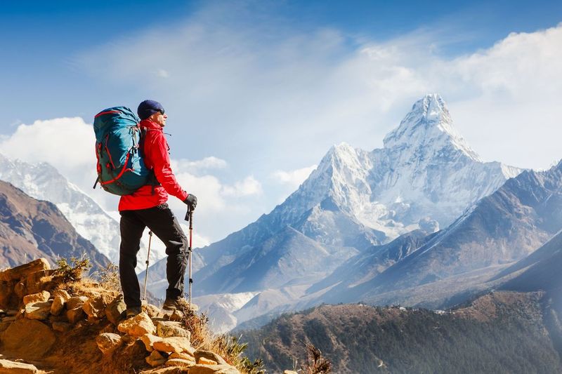 A hiker enjoying the view of mountains in front of him | Photo: Shutterstock