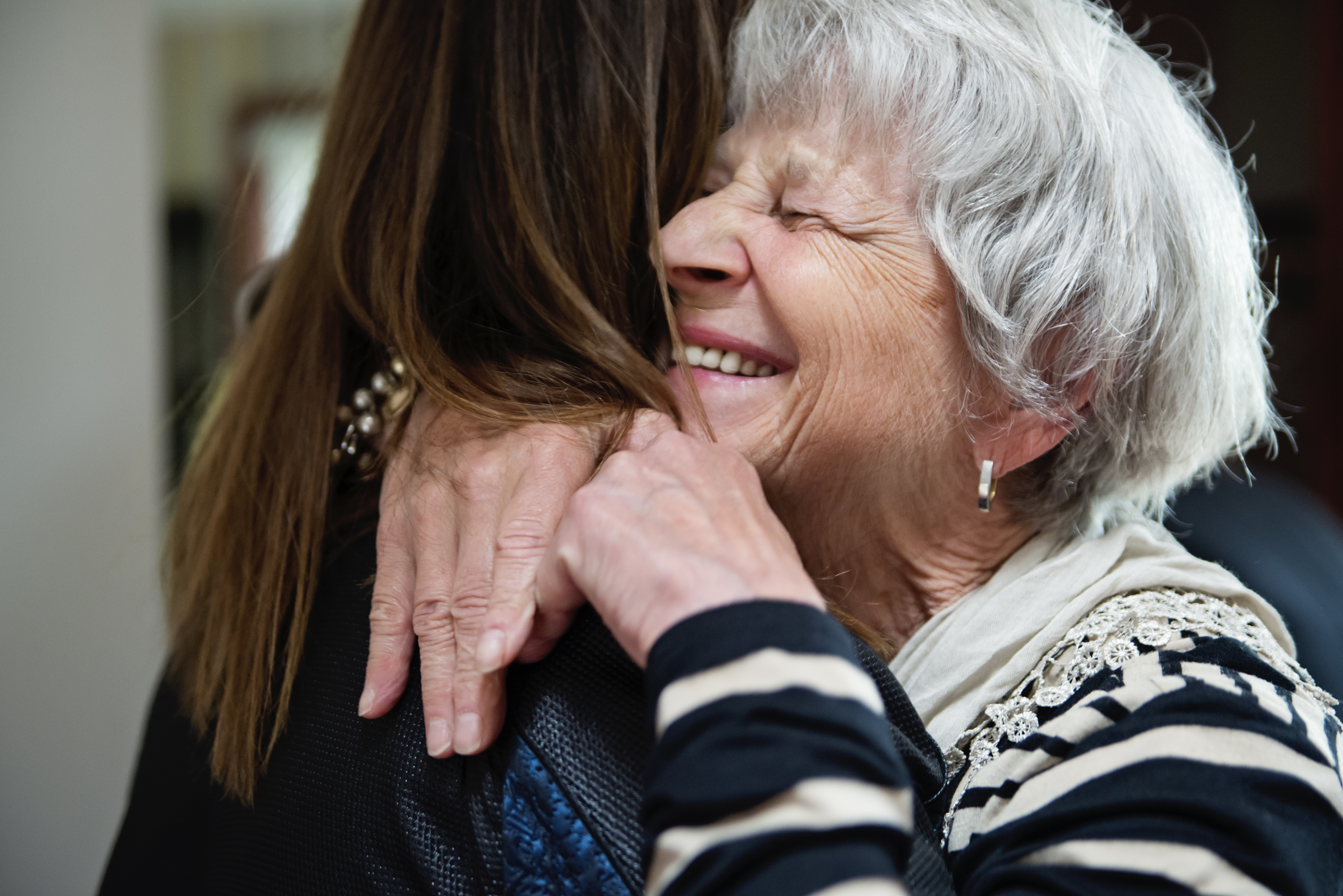 A senior grandmother hugging her granddaughter | Source: Getty Images
