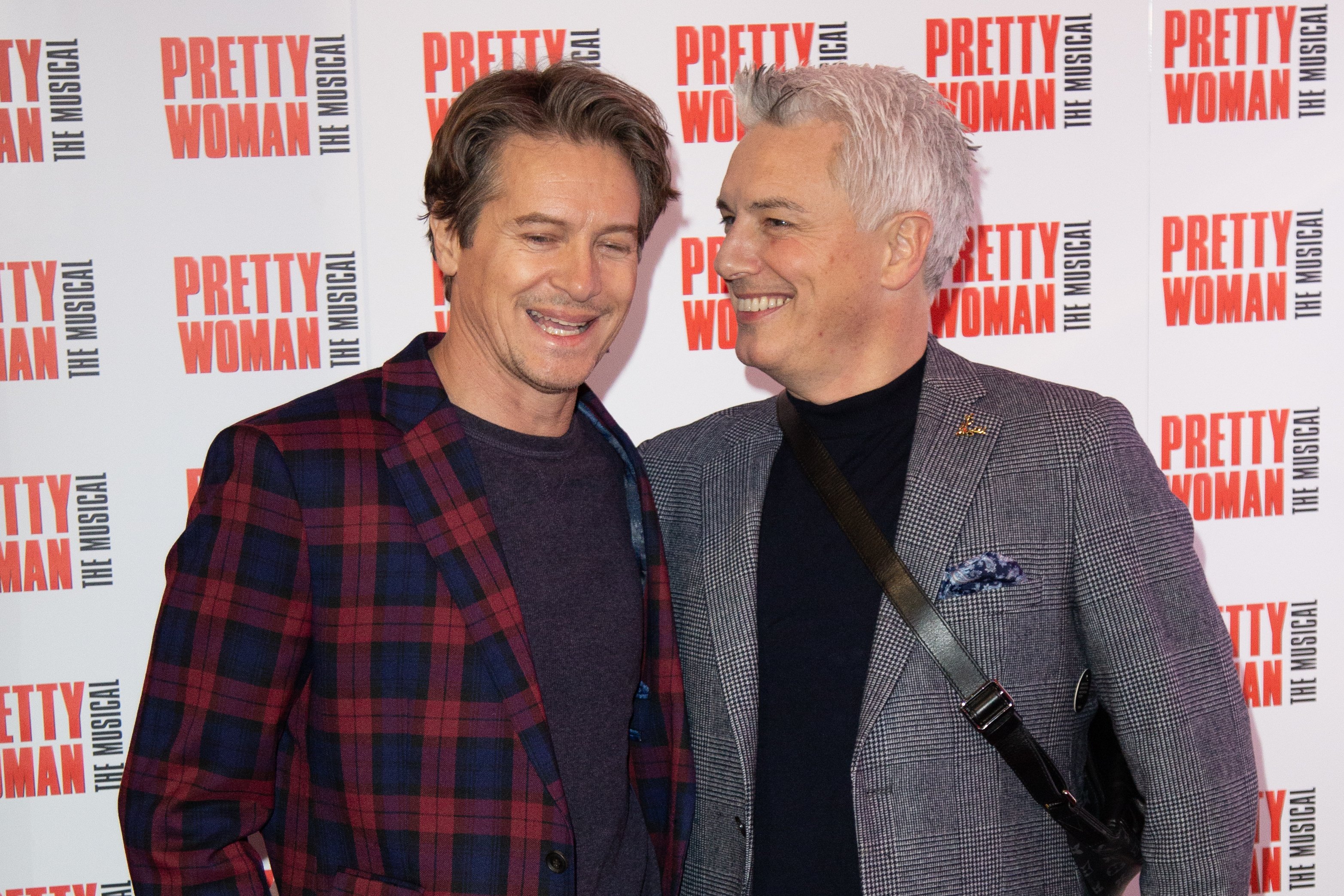 Scott Gill and John Barrowman attend the press night performance of ''Pretty Woman'' at the Piccadilly Theatre, on March 2, 2020, in London, England. | Source: Getty Images