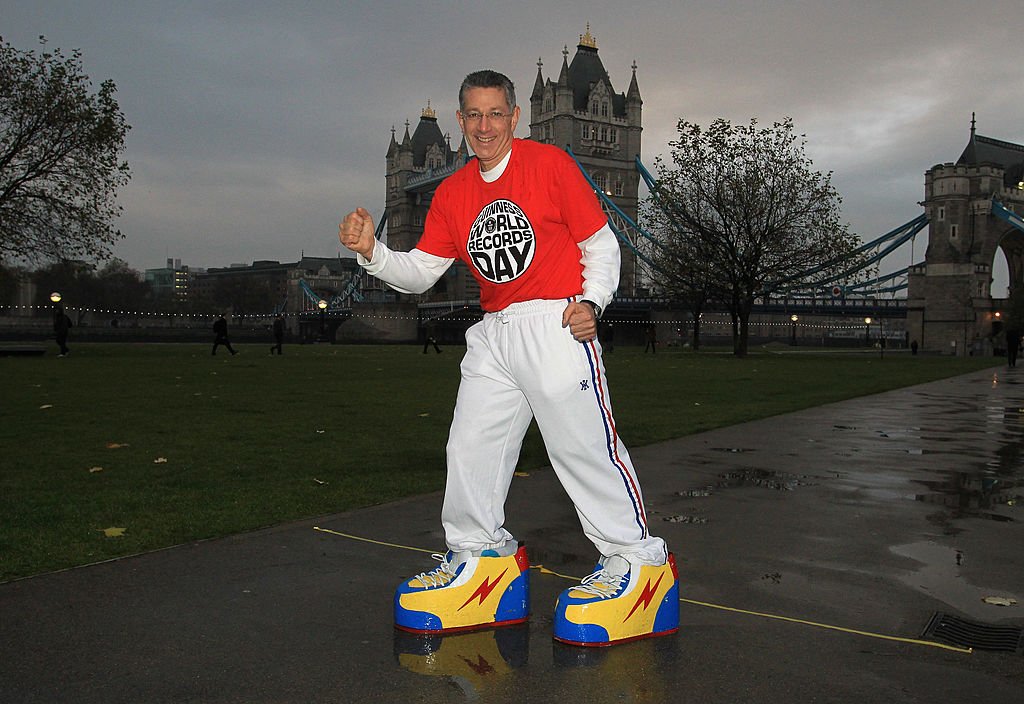 Ashrita Furman during his record attempt 'heaviest shoes walked in' on Guinness World Records day at Pottersfield Park on November 18, 2010 in London, England | Photo: Getty Images