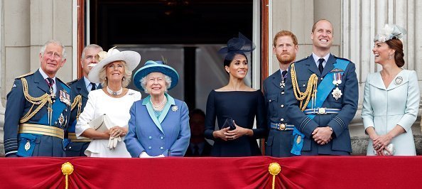 Prince Charles, Camilla, Duchess of Cornwall, Queen Elizabeth II, Meghan, Duchess of Sussex, Prince Harry, Duke of Sussex, Prince William, Duke of Cambridge and Catherine, Duchess of Cambridge watch a flypast to mark the centenary of the Royal Air Force | Photo: Getty Images