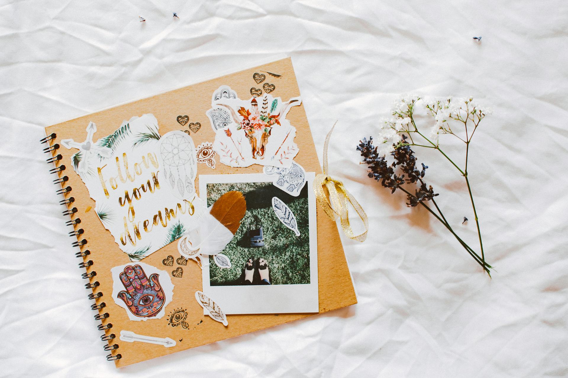 A scrapbook lying on a white cloth | Source: Pexels