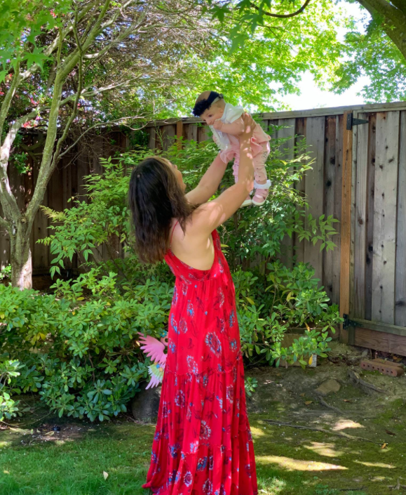 Eliza Jamkochian Bahneman holding her baby Isabella up in the air. | Source: Facebook.com/elizabeth.jamkochian