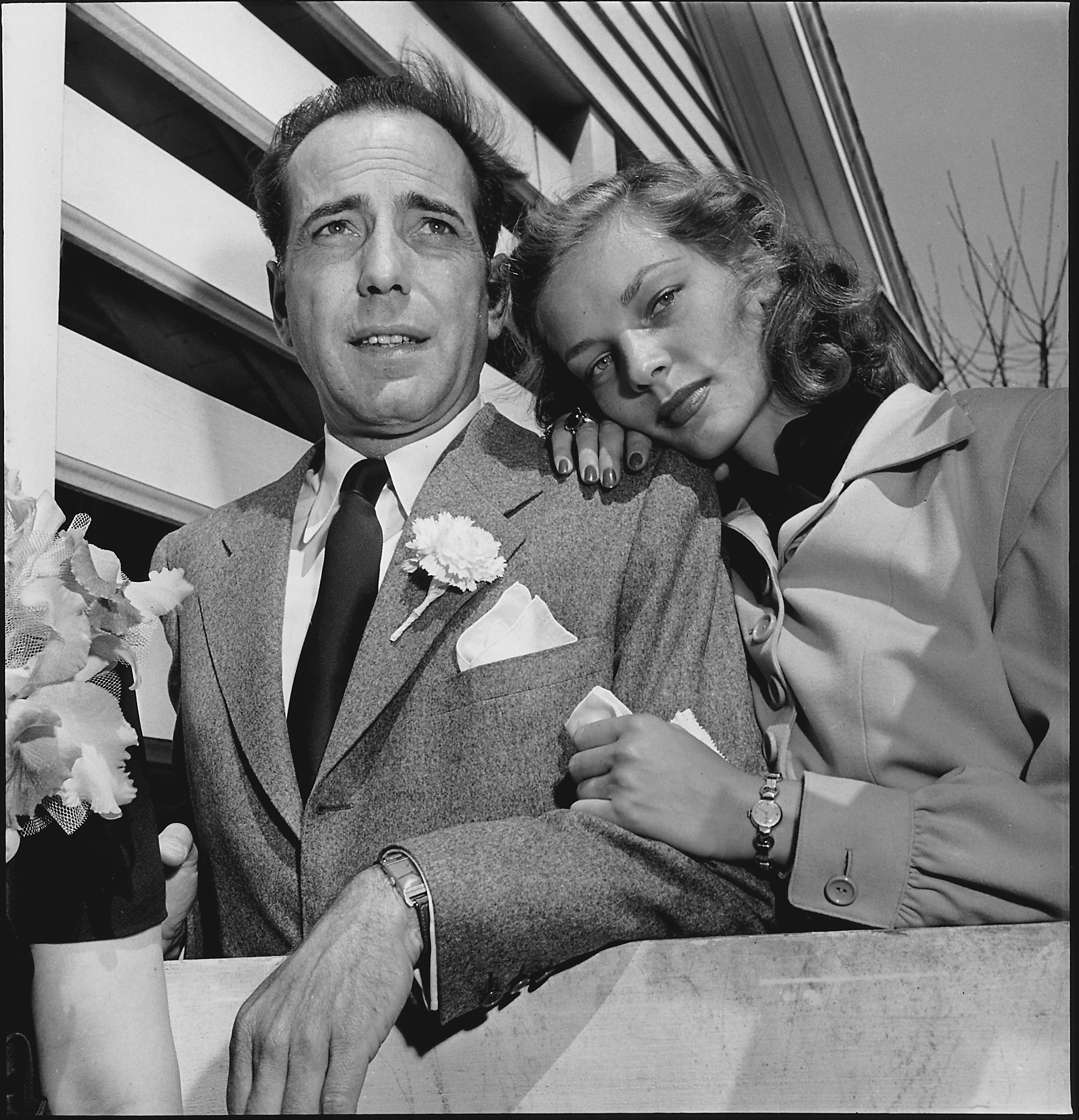 Humphrey Bogart and Lauren Bacall attending wedding reception at home of novelist Louis Bromfeld. | Source: Getty Images