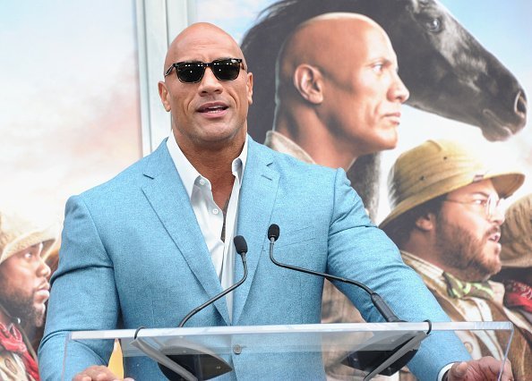  Dwayne Johnson speaks at Kevin Hart's Hand And Footprint Ceremony At the Theatre IMAX held at TCL Chinese Theatre on December 10, 2019 in Hollywood, California.| Photo:Getty Images
