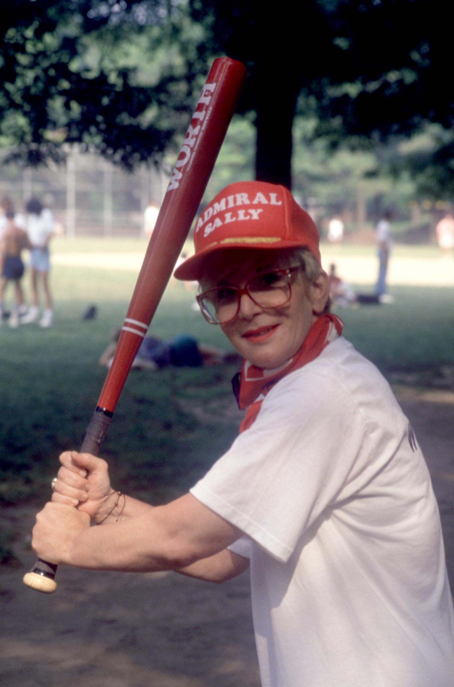 Sally Jessy Raphael gears up with a bat and a bold "Admiral Sally" cap before a charity softball game in New York City, circa 1980.
