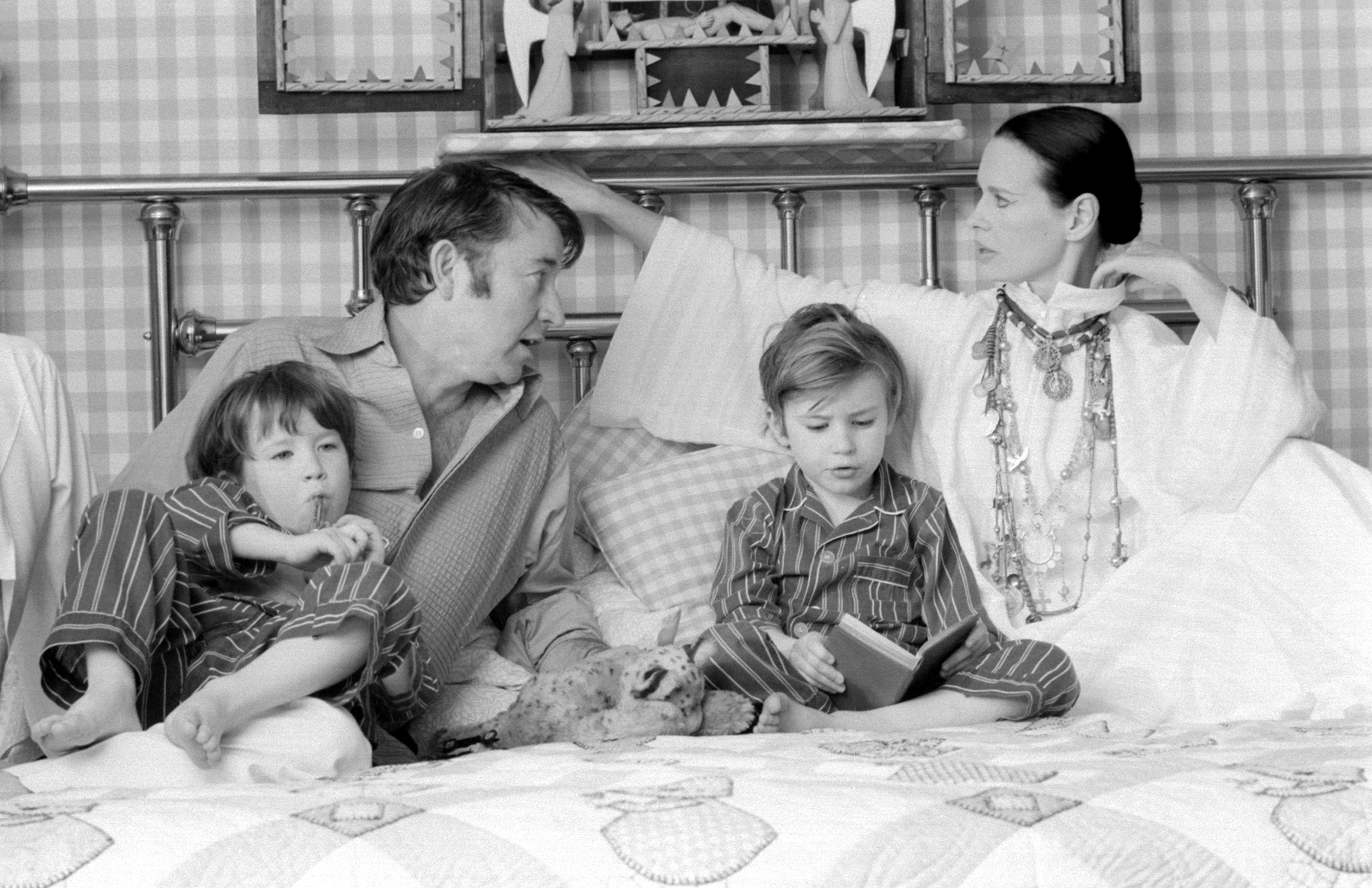 Actor and author Wyatt Emory Cooper, Carter Vanderbilt Cooper, Anderson Cooper, American heiress and socialite Gloria Vanderbilt pose for a family portrait as they play on a bed in their home on March 30, 1972 in Southampton, Long Island, New York. | Source: Getty Images
