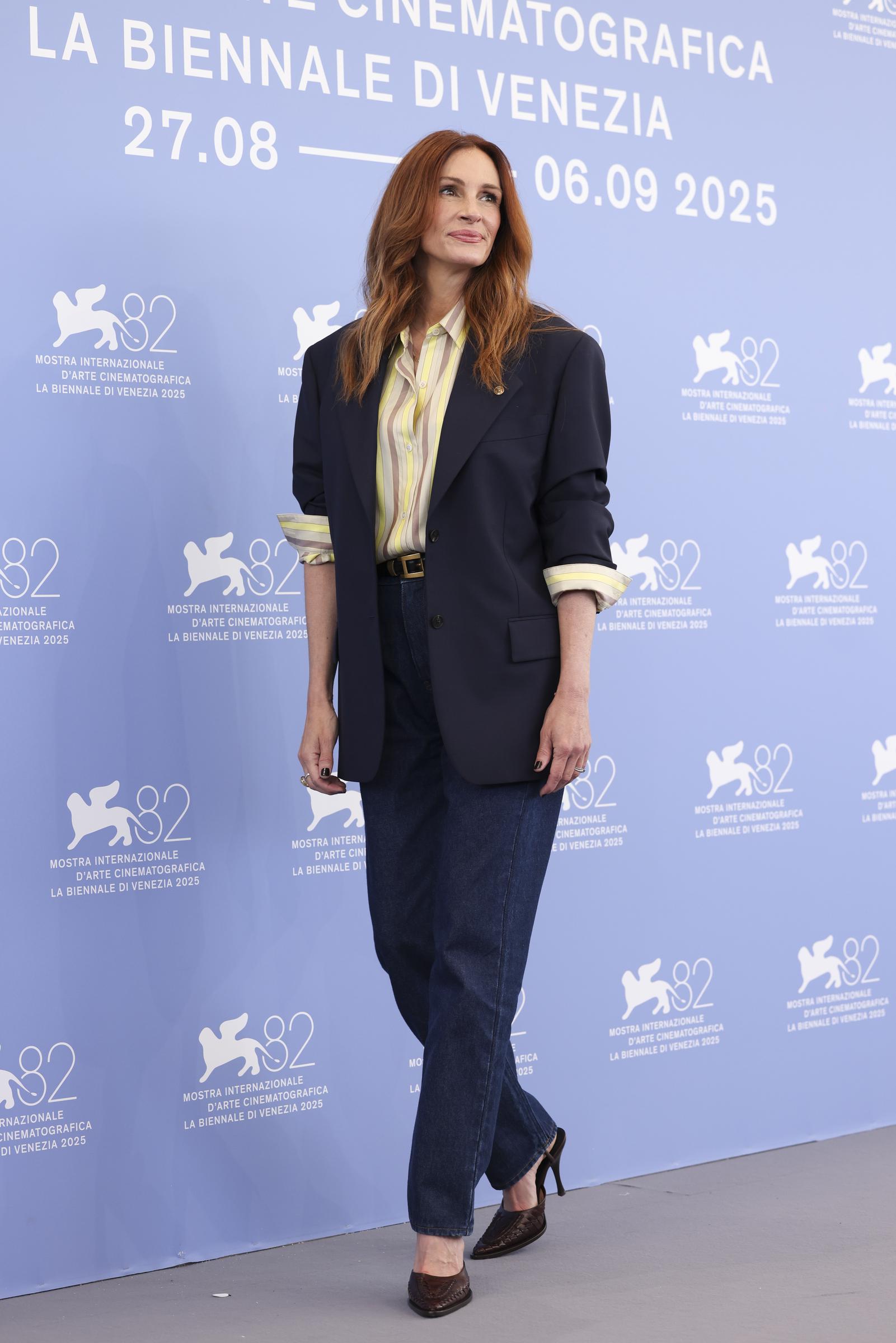 Julia Roberts attends the "After the Hunt" photocall during the 82nd Venice International Film Festival on August 29, 2025, in Venice, Italy. She poses in front of the poster with her signature gentle smile, looking stunning.