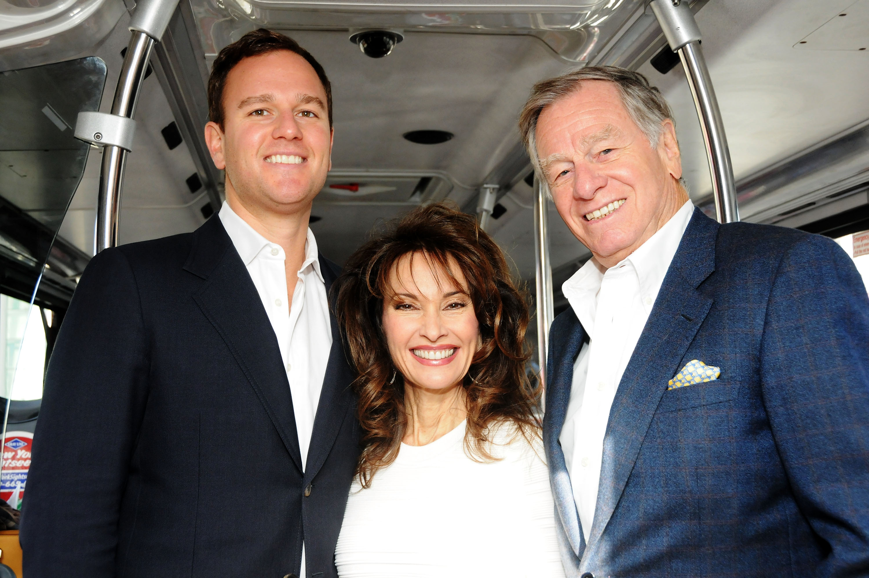 Susan Lucci (center), accompanied by her son Andreas Huber (left) and husband Helmut Huber (right), attending Gray Line New York's Ride Of Fame Honors Susan Lucci at Pier 78 in New York City on November 19, 2013 | Source: Getty Images