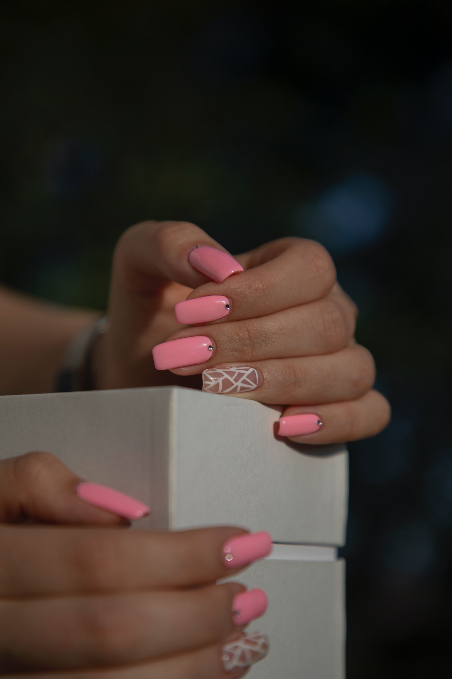 Female hands adorned with pink nail polish | Source: Pexels