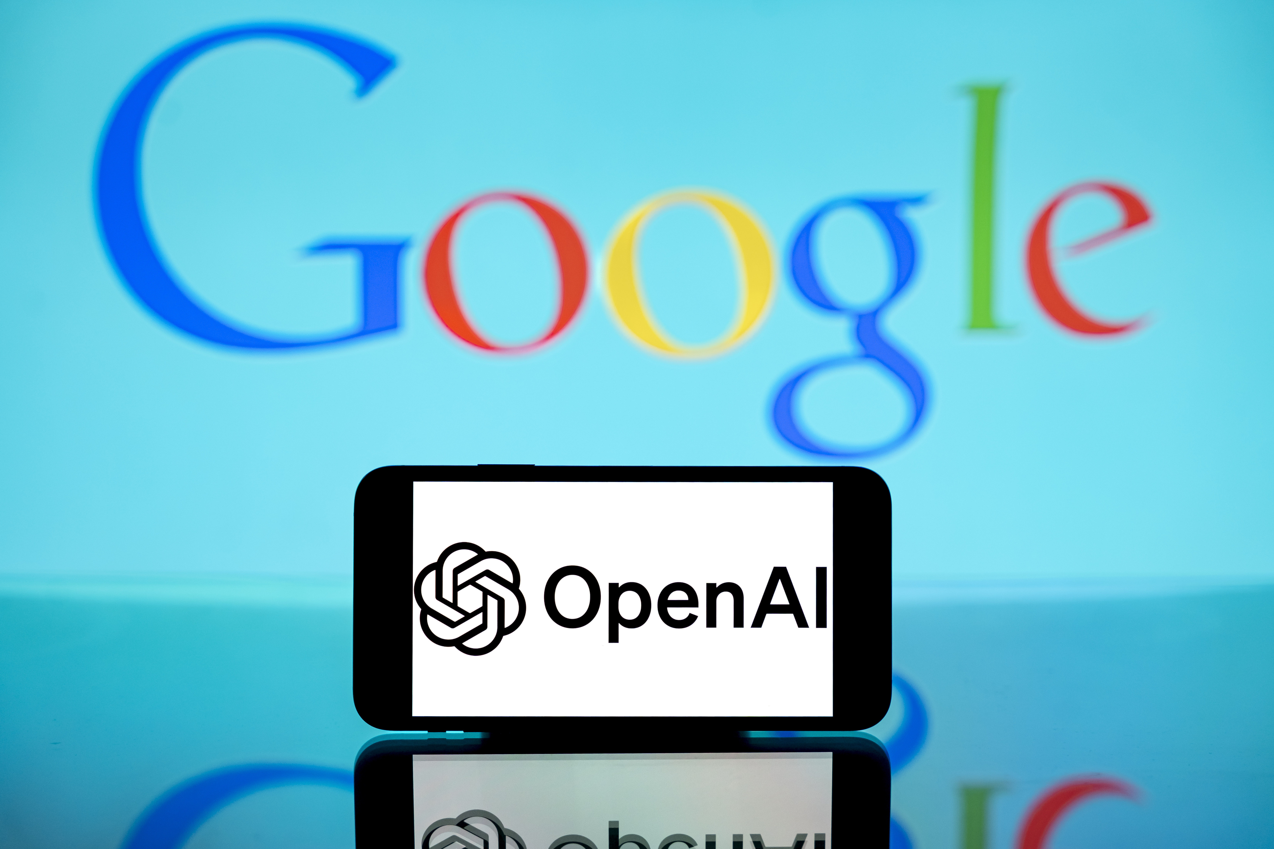 The OpenAI logo shown on a mobile screen and the Google logo as a backdrop; photo taken in India on December 12, 2024 | Source: Getty Images