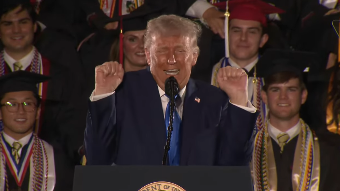 Donald Trump clenches his fists as part of a weightlifting impression, drawing laughter from graduates at the 2025 University of Alabama commencement.