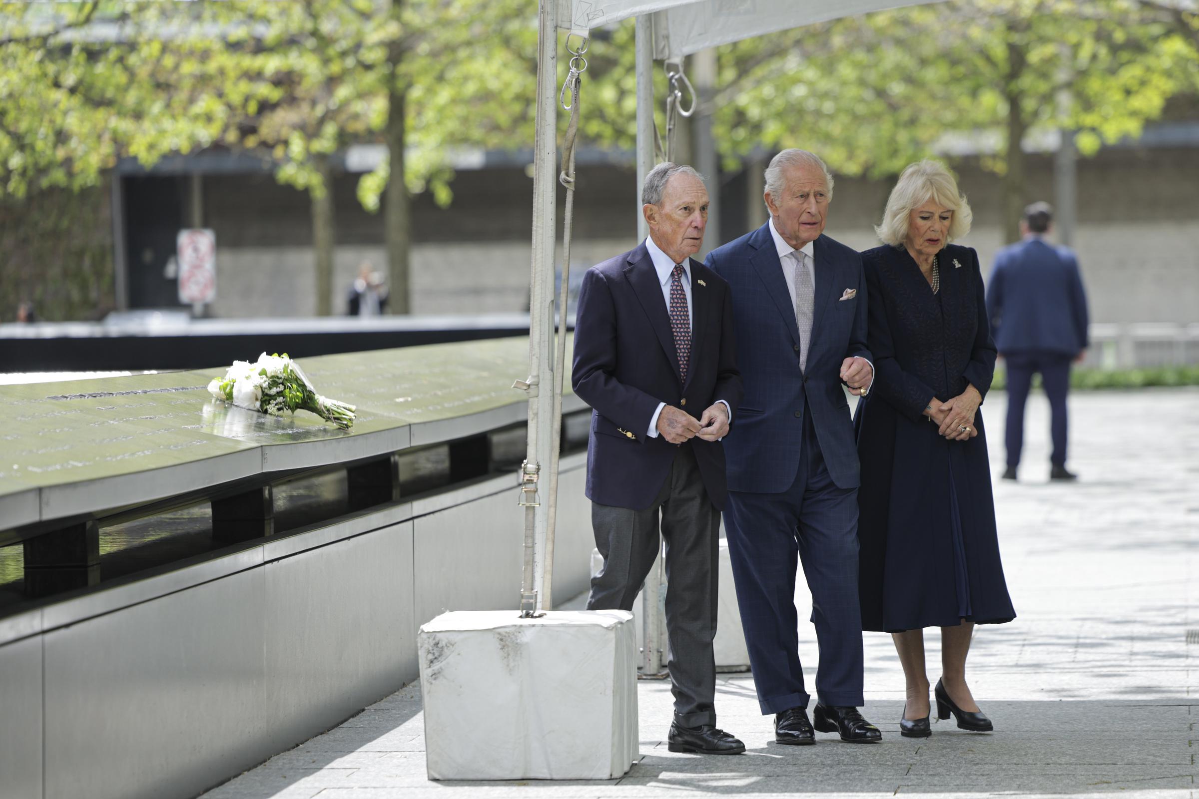 Michael Bloomberg, King Charles III, and Queen Camilla walk past the reflecting pool at the 9/11 Memorial in New York City on April 29, 2026 | Source: Getty Images