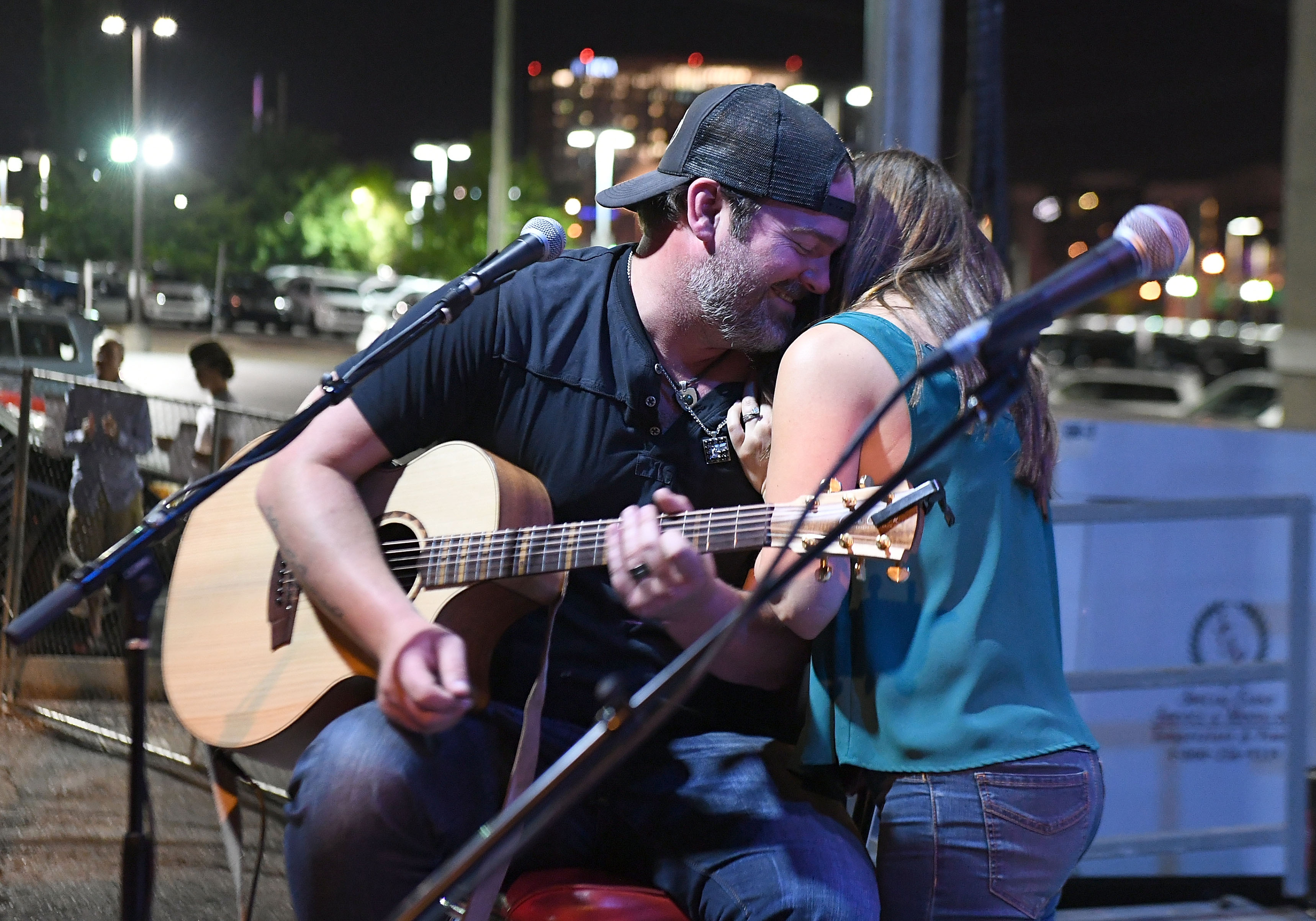 Lee Brice embraces his wife Sara Reeveley after serenading her during Lewispalooza on June 5, 2018 in Nashville. | Source: Getty Images