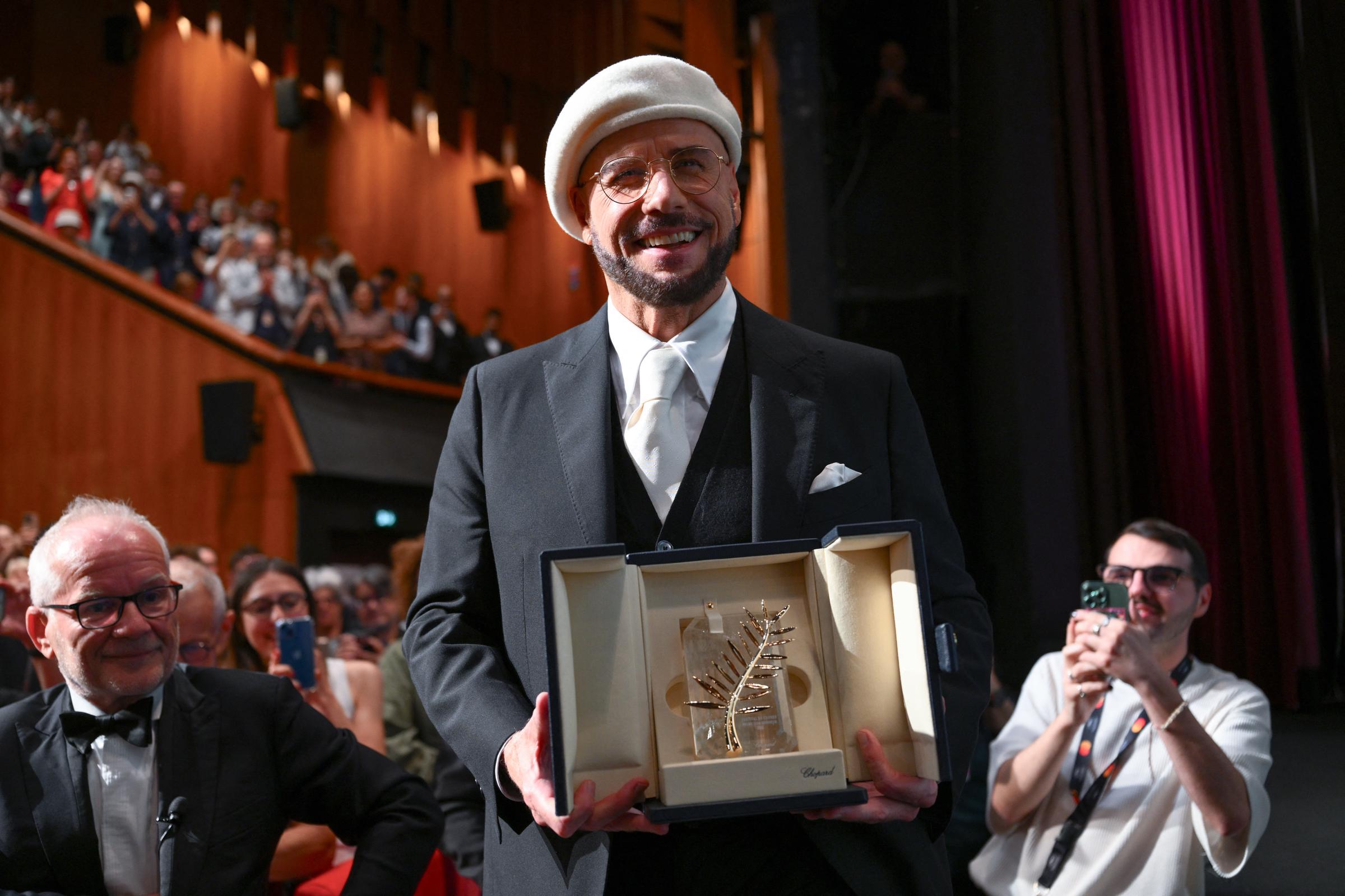 John Travolta accepts the Honorary Palme Award onstage during the 79th annual Cannes Film Festival at Plage Macé on May 15, 2026 in Cannes, France. | Source: Getty Images