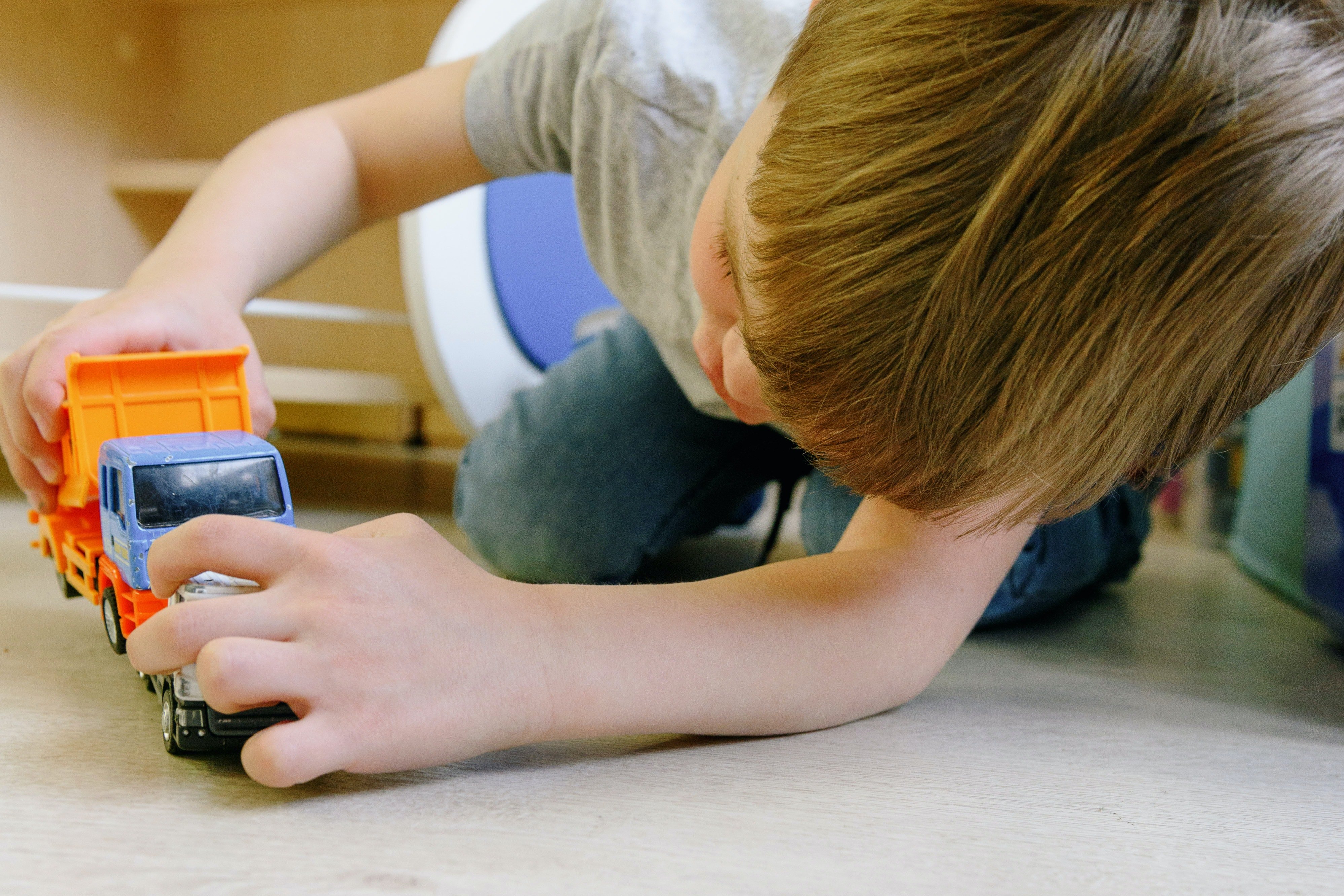 A little boy playing with a toy car | Source: Pexels