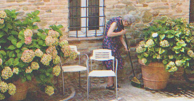 An old lady sweeping the floor | Source: Shutterstock
