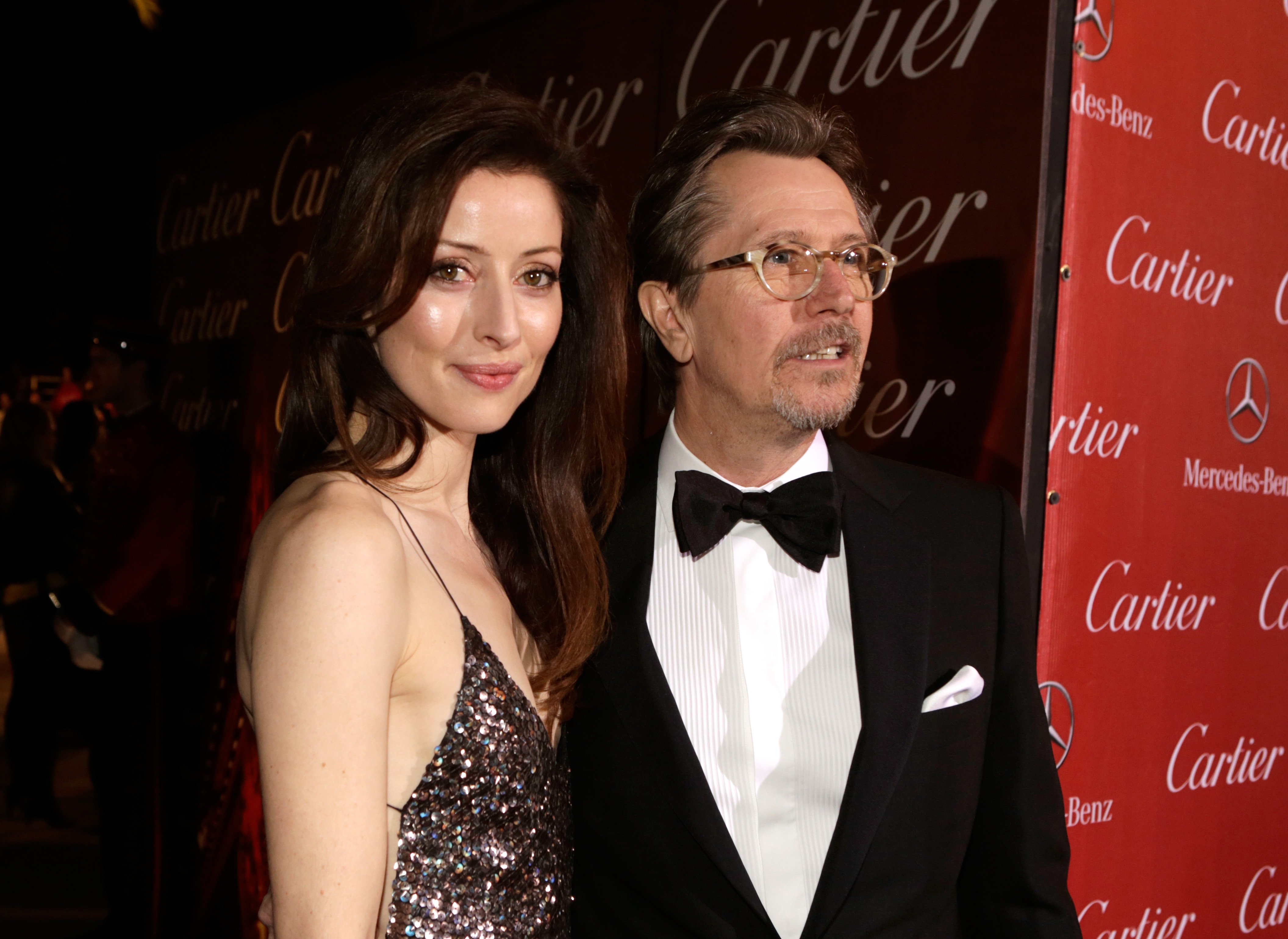 Actor Gary Oldman (R) and Alexandra Edenborough arrive at the 25th annual Palm Springs International Film Festival awards gala at Palm Springs Convention Center on January 4, 2014 in Palm Springs, California. | Source: Getty Images