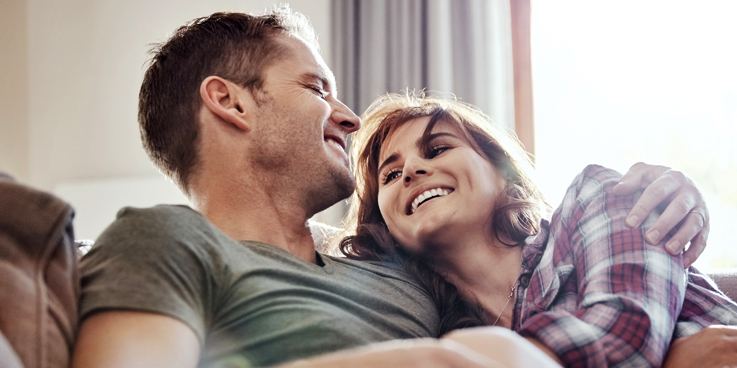 A husband and wife laughing | Source: Shutterstock