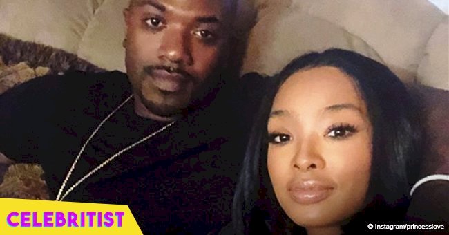 Princess Love & Ray J pose in all red with their baby daughter with full head of hair in new pic