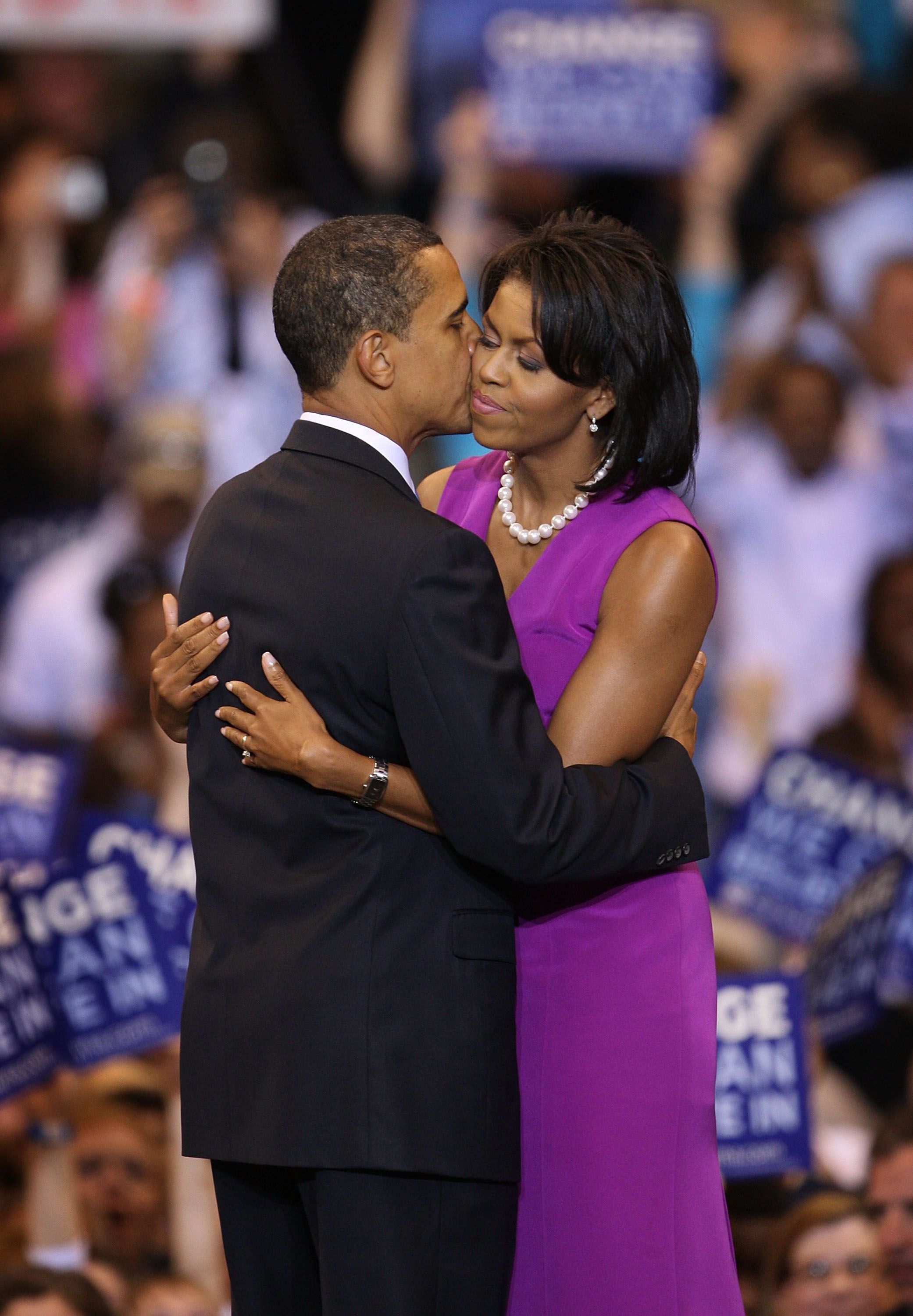 ​​​Barack Obama kisses his wife Michelle Obama during an election night rally at the Xcel Energy Center June 3, 2008 in St. Paul, Minnesota | Source: Getty Images