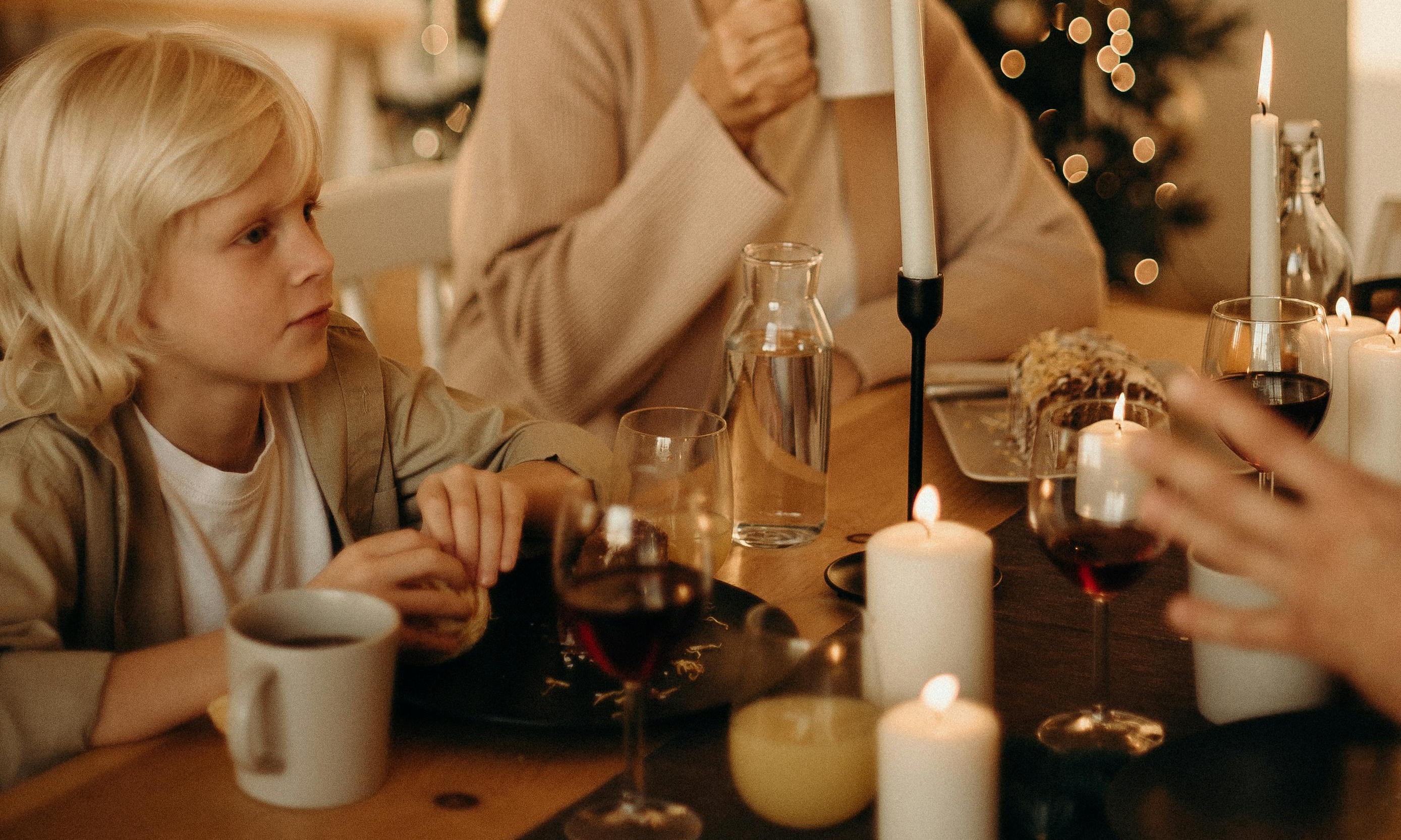 A boy at a family dinner table | Source: Pexels