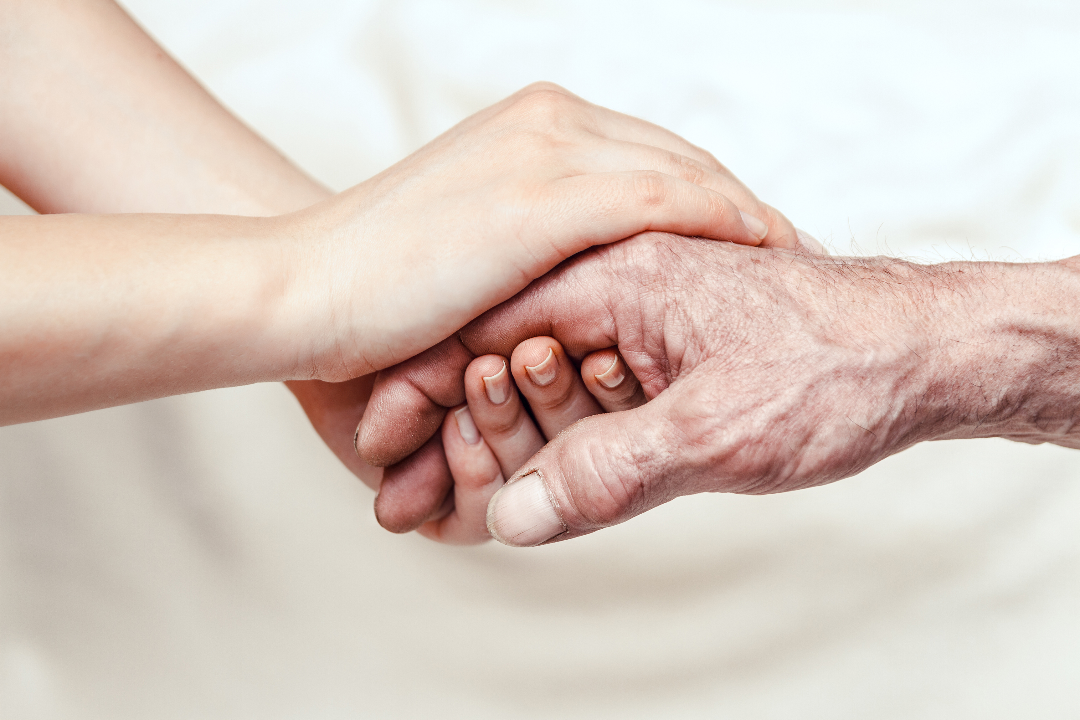 Hands of the old woman and a young woman | Source: Shutterstock