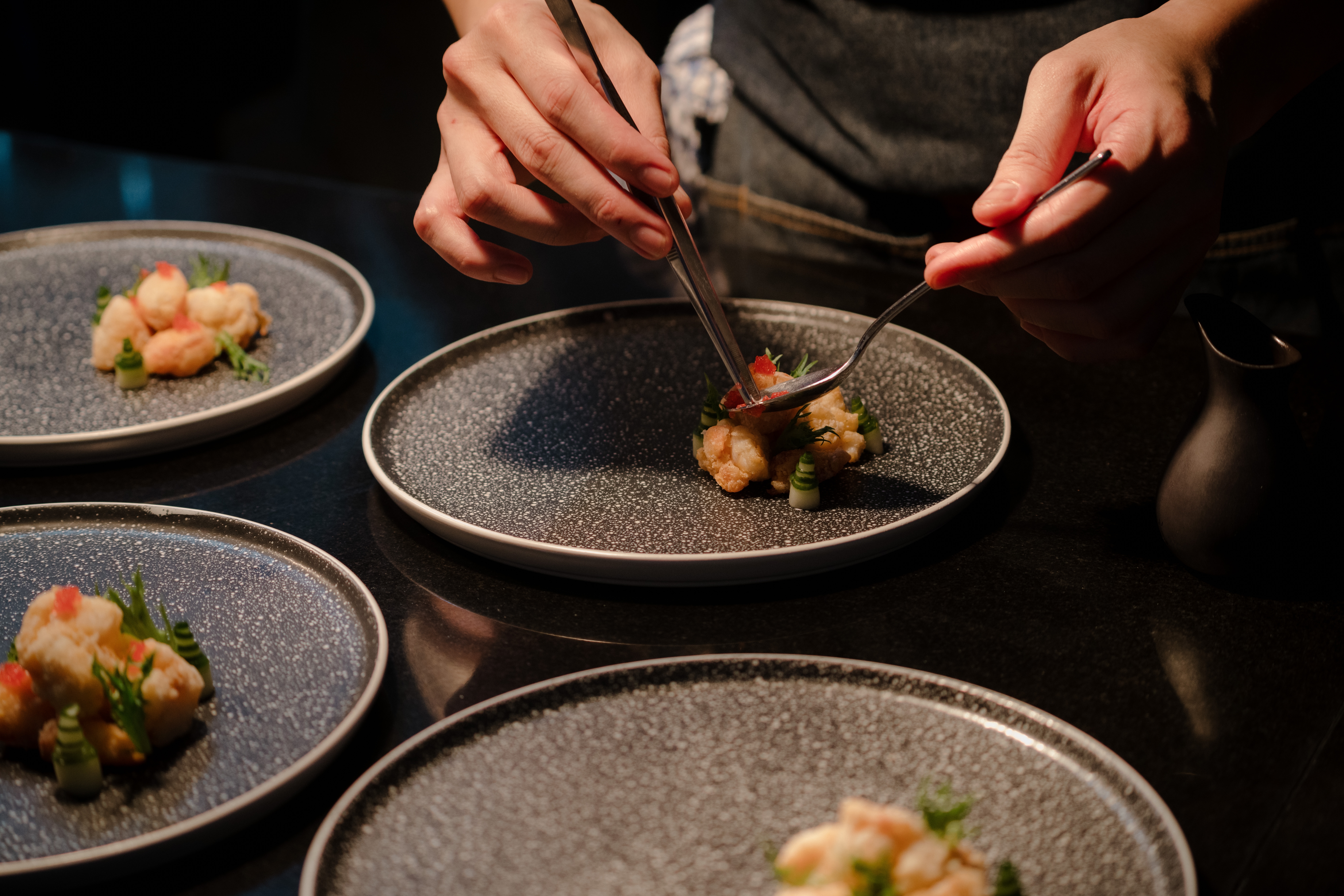 Plates being prepared in the kitchen of a fine dining restaurant | Source: Shutterstock