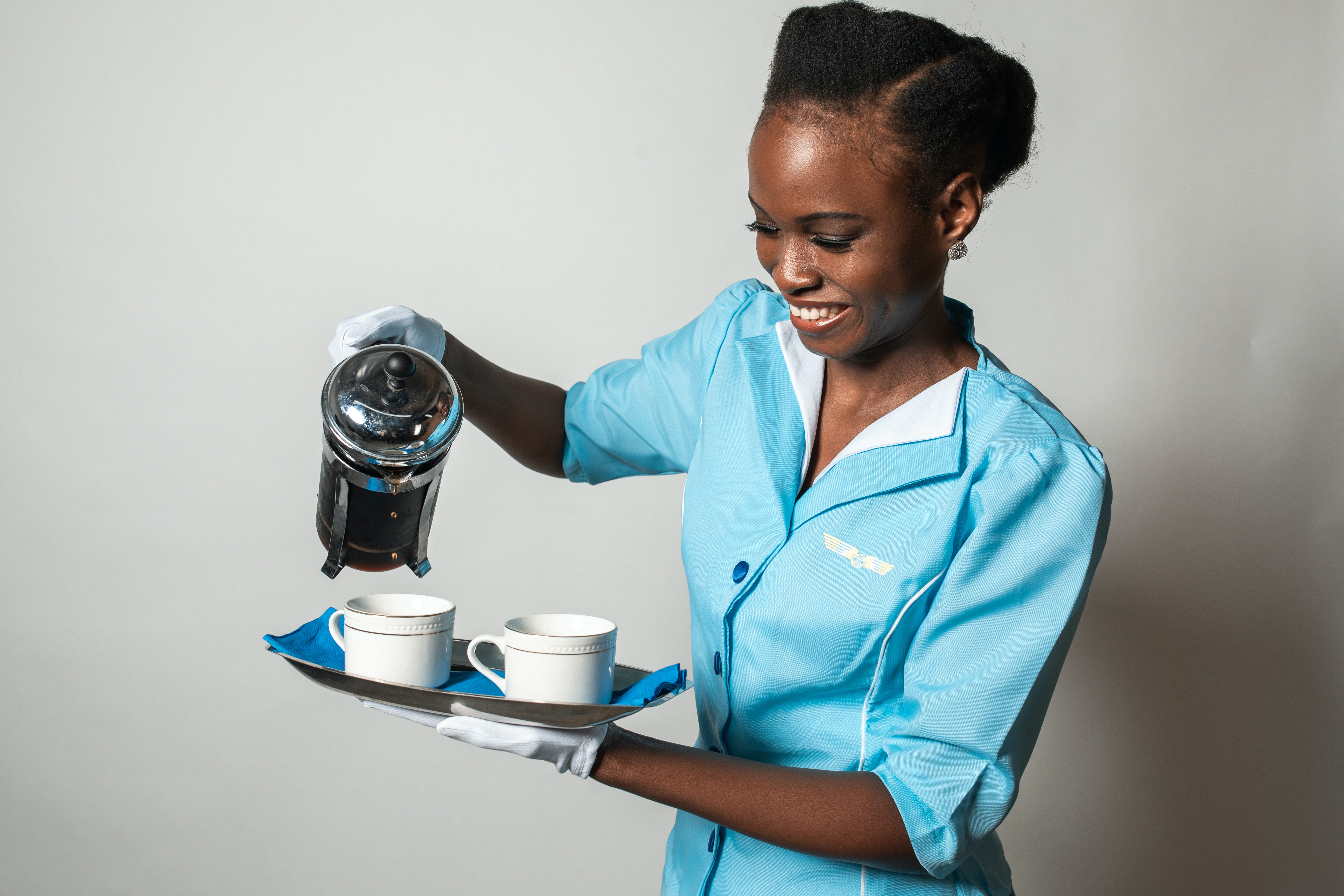 Flight attendant serving coffee | Source: Pexels
