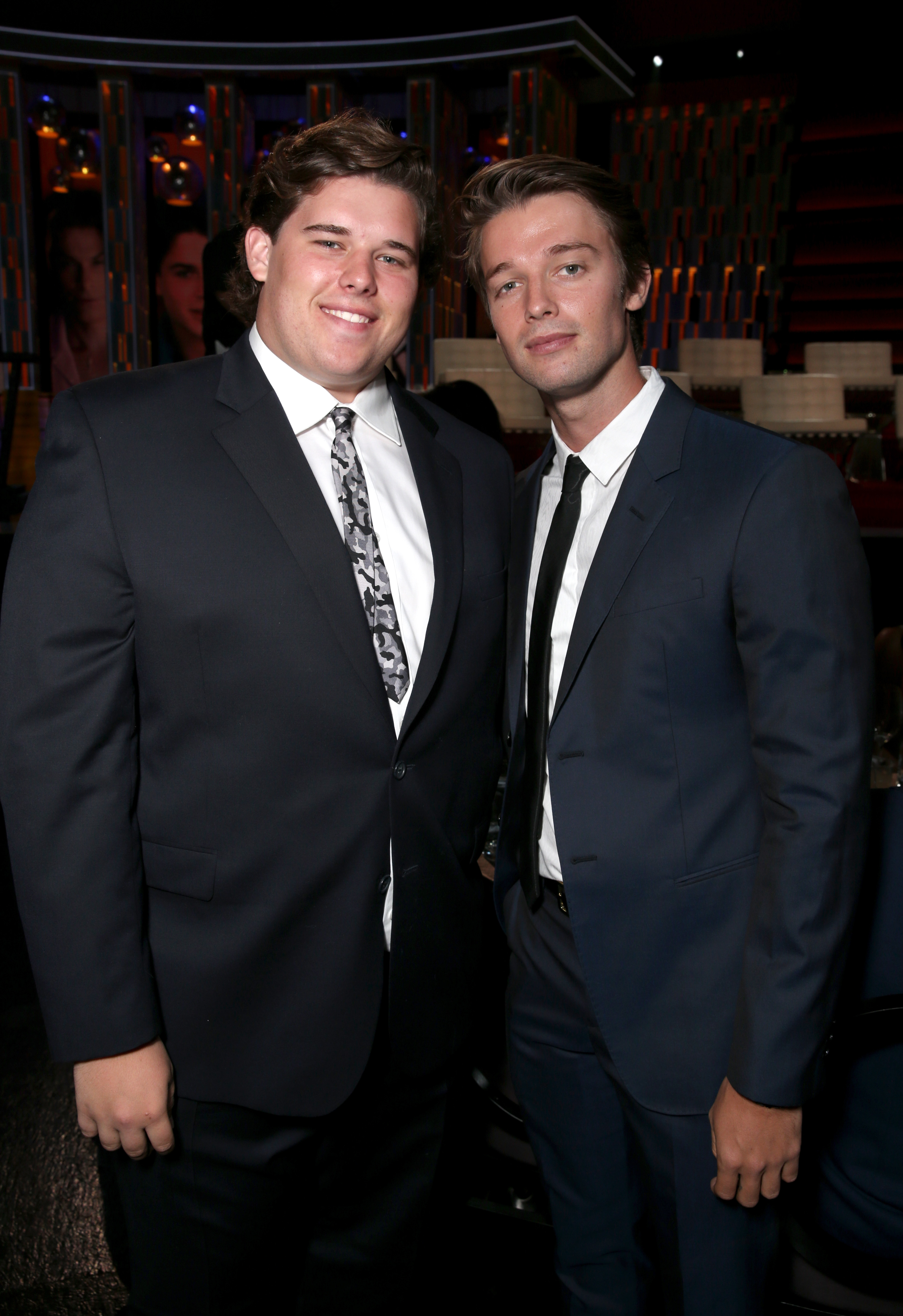 Christopher Schwarzenegger poses with his brother Patrick at The Comedy Central Roast of Rob Lowe in Los Angeles, in August 2016. Dressed in a dark suit with a patterned tie, Christopher appears with a fuller build and swept-back hair, smiling warmly during the evening event.