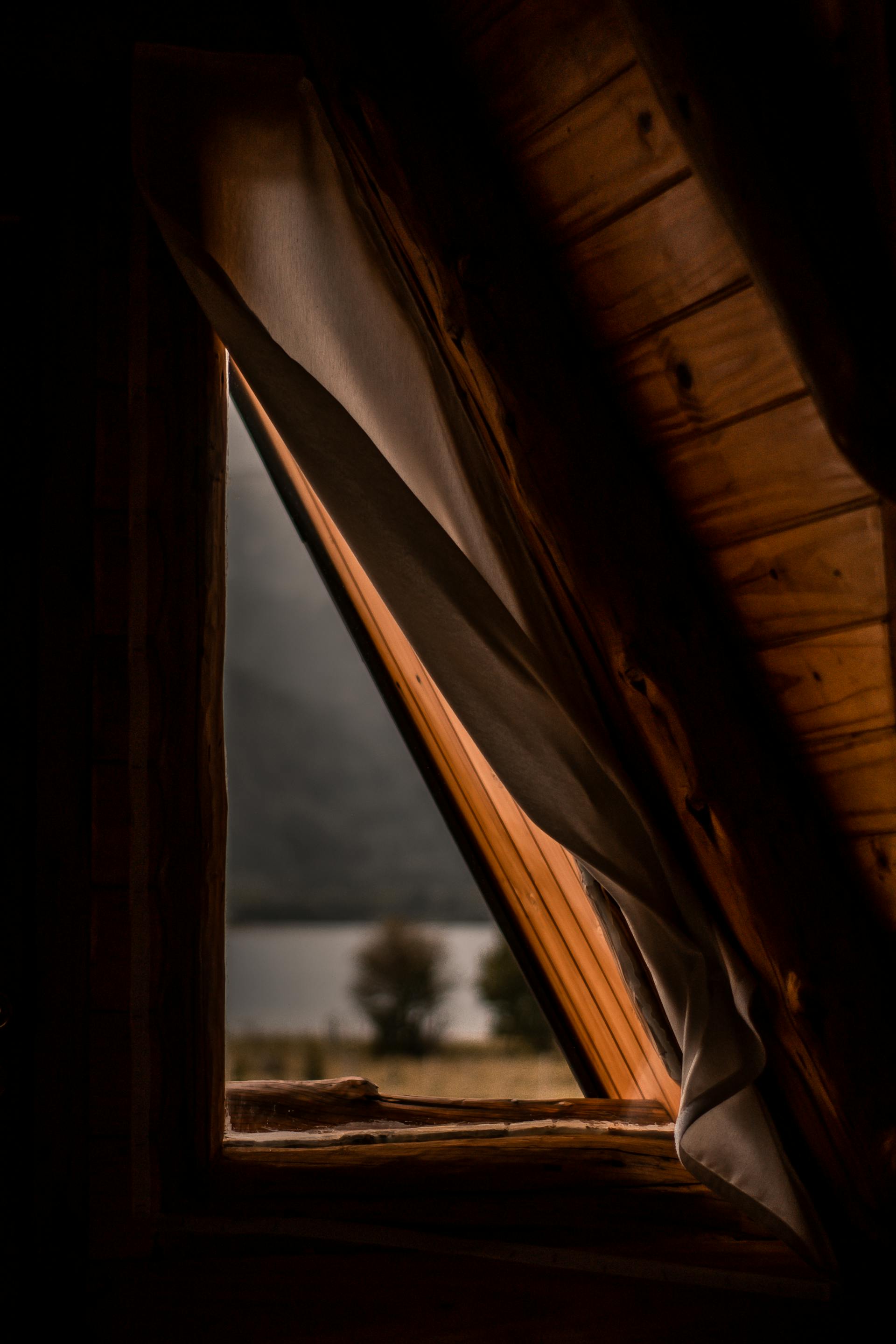 A closeup shot of a triangular window in an attic | Source: Pexels