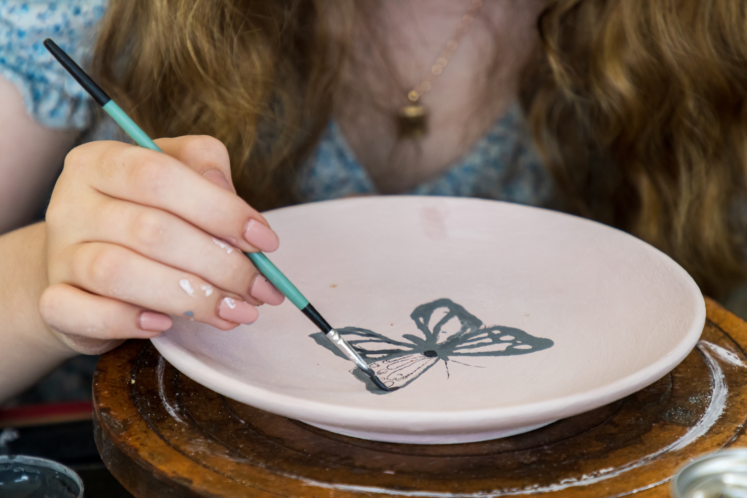 Person painting on pottery | Source: Unsplash