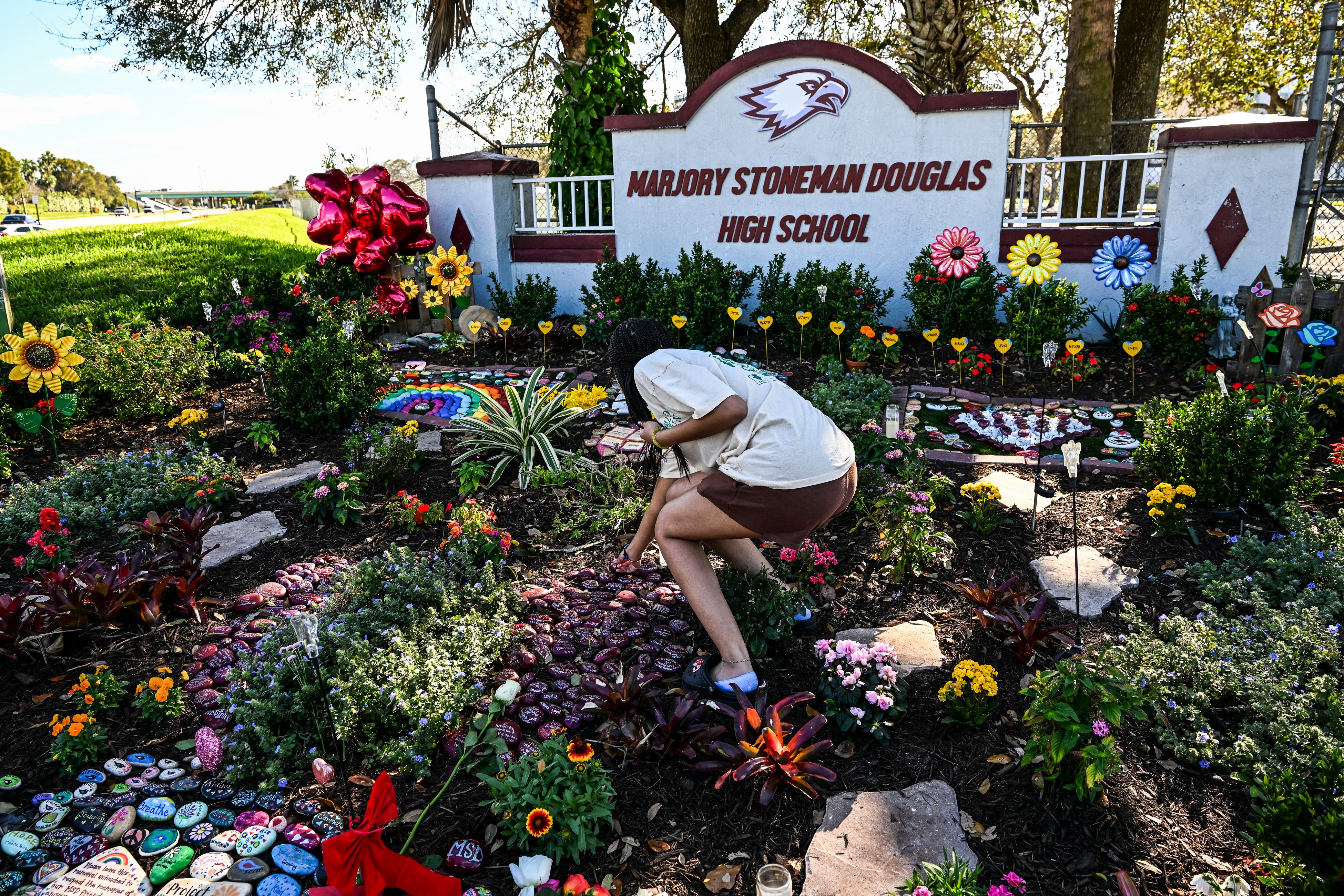 A person visits the memorial for victims of the 2018 Parkland school shooting on the fifth anniversary, February 14, 2023 | Source: Getty Images