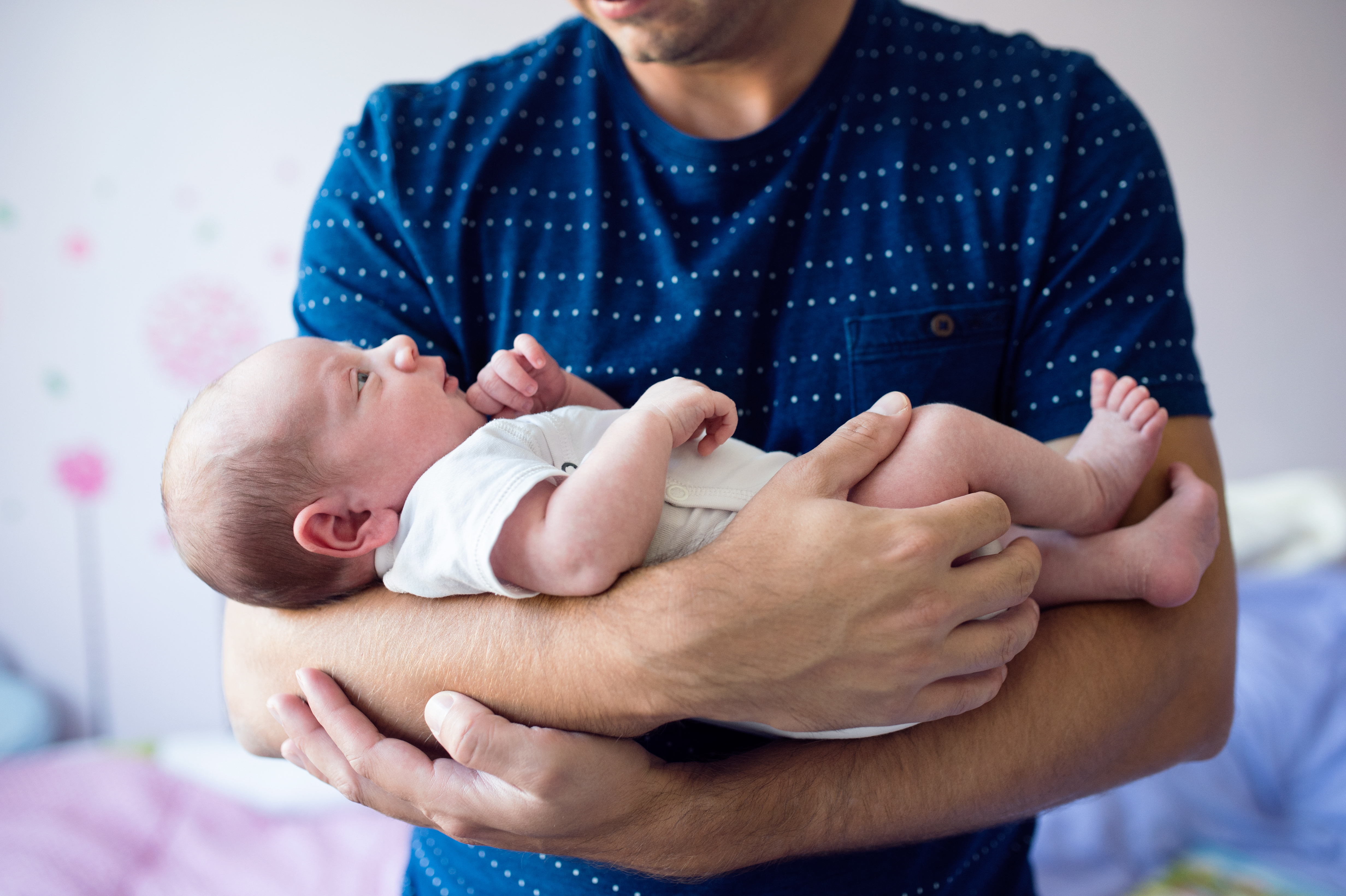 A man holding a baby | Source: Shutterstock
