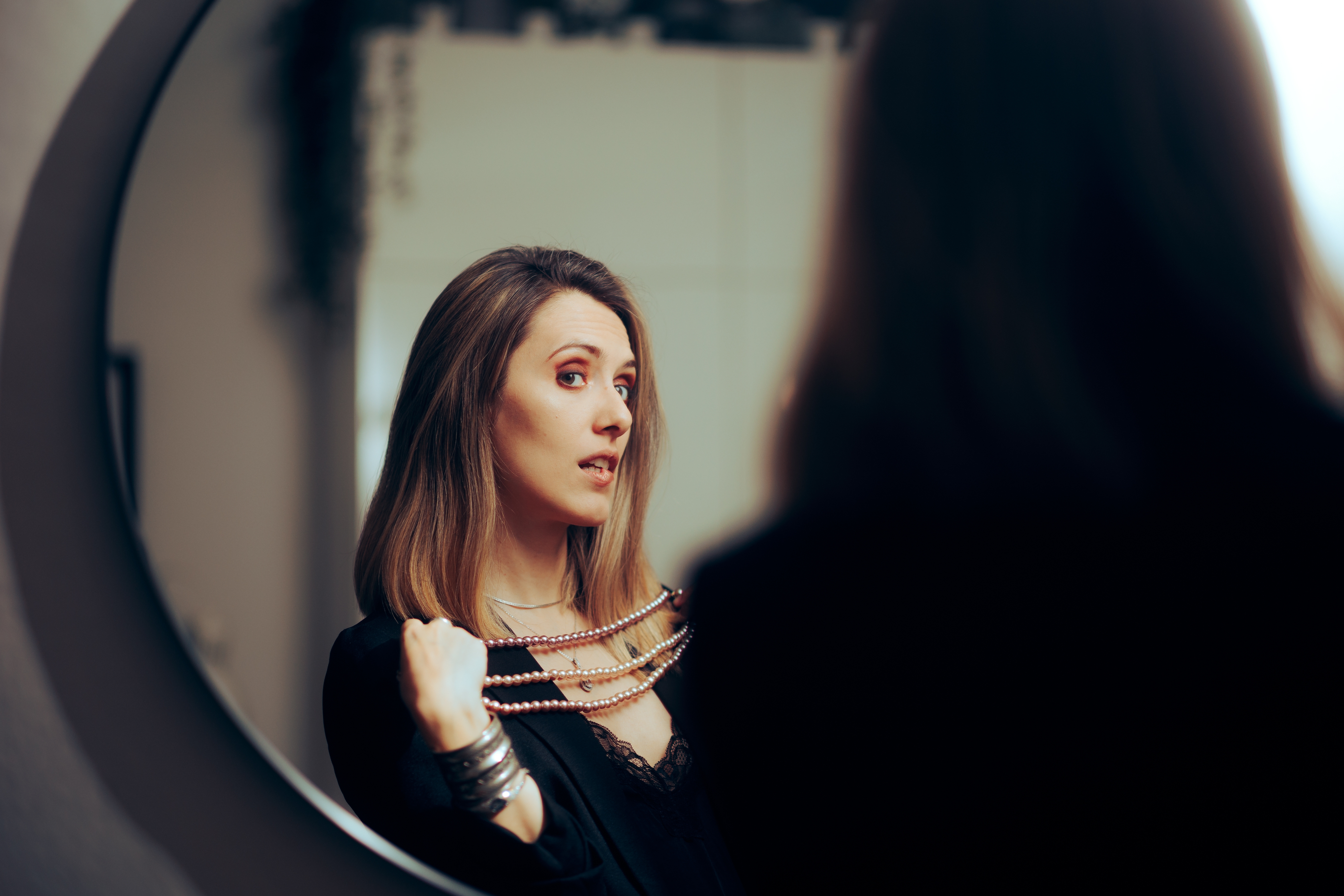 A woman looking at herself in the mirror | Source: Shutterstock