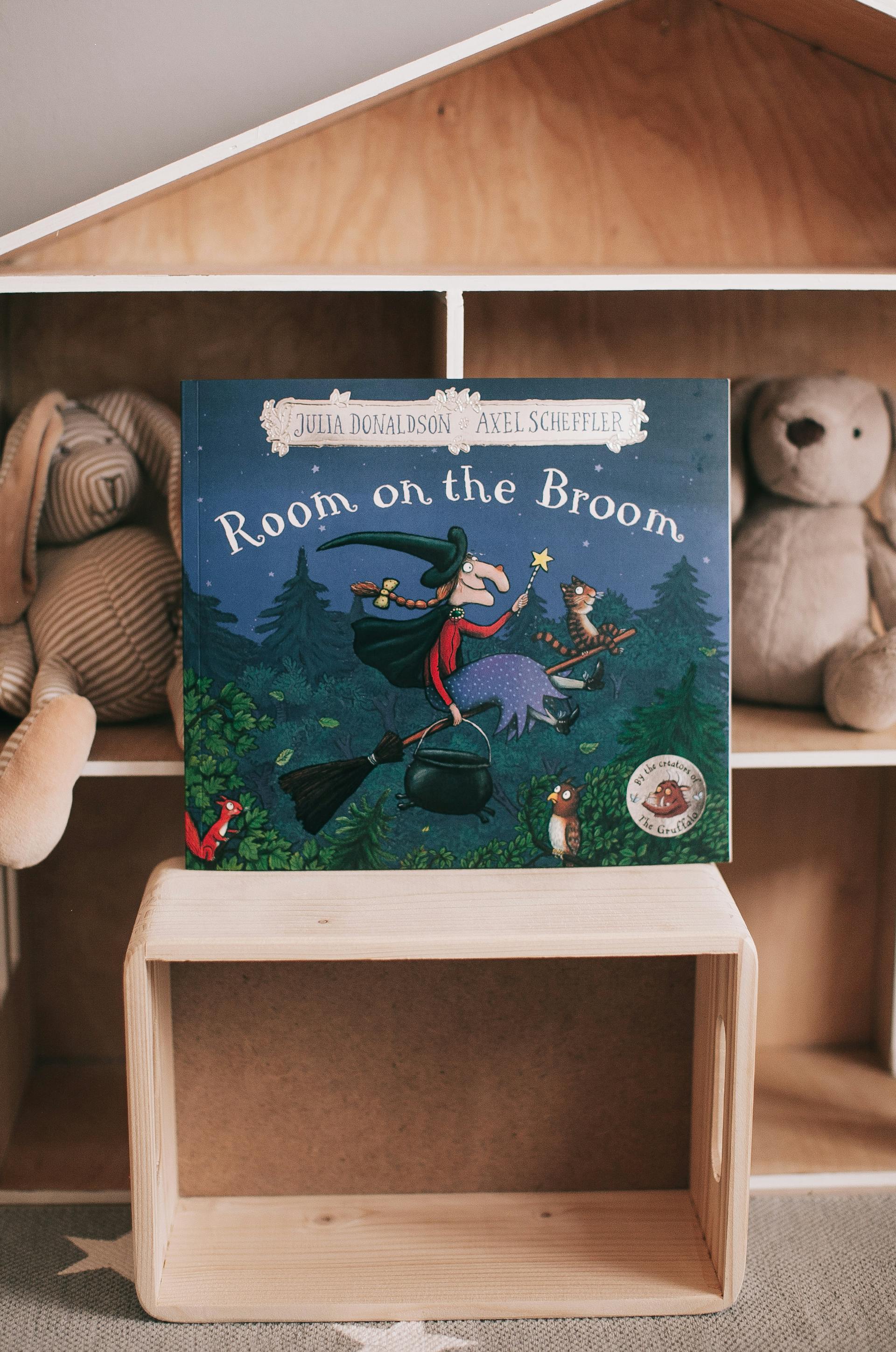 A children's book lying next to stuffed bears on a rack | Source: Pexels