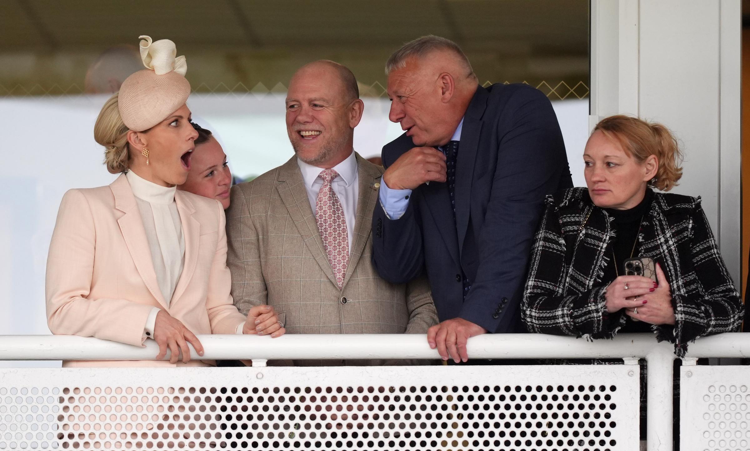A lively balcony moment captured Zara Tindall mid-reaction, her expression animated as she shared a lighthearted exchange with another guest, while Mia Tindall leaned in &mdash; the scene reflecting both the social buzz of the event and the family's easy rapport.
