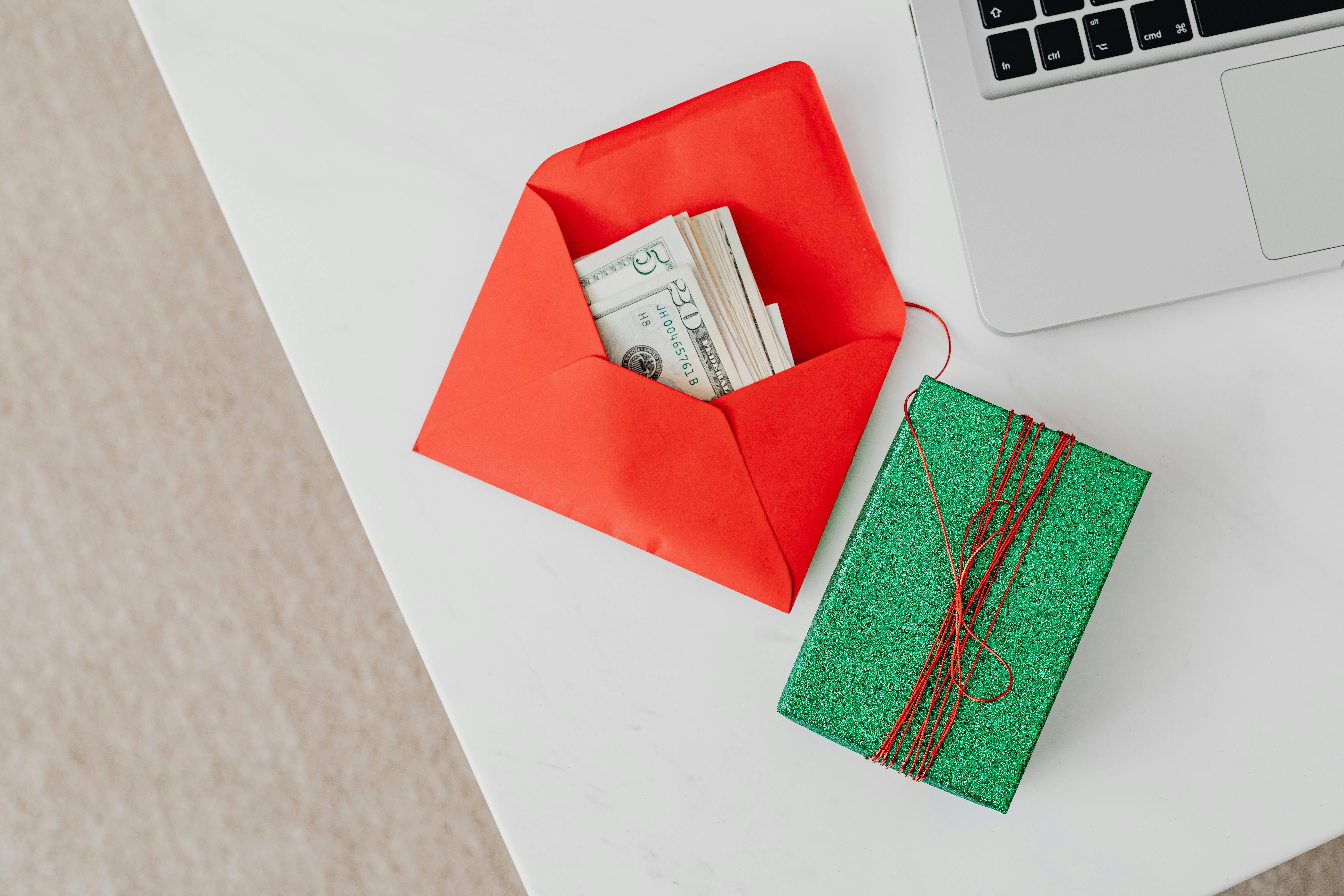 Some money in an envelope near a box | Source: Pexels