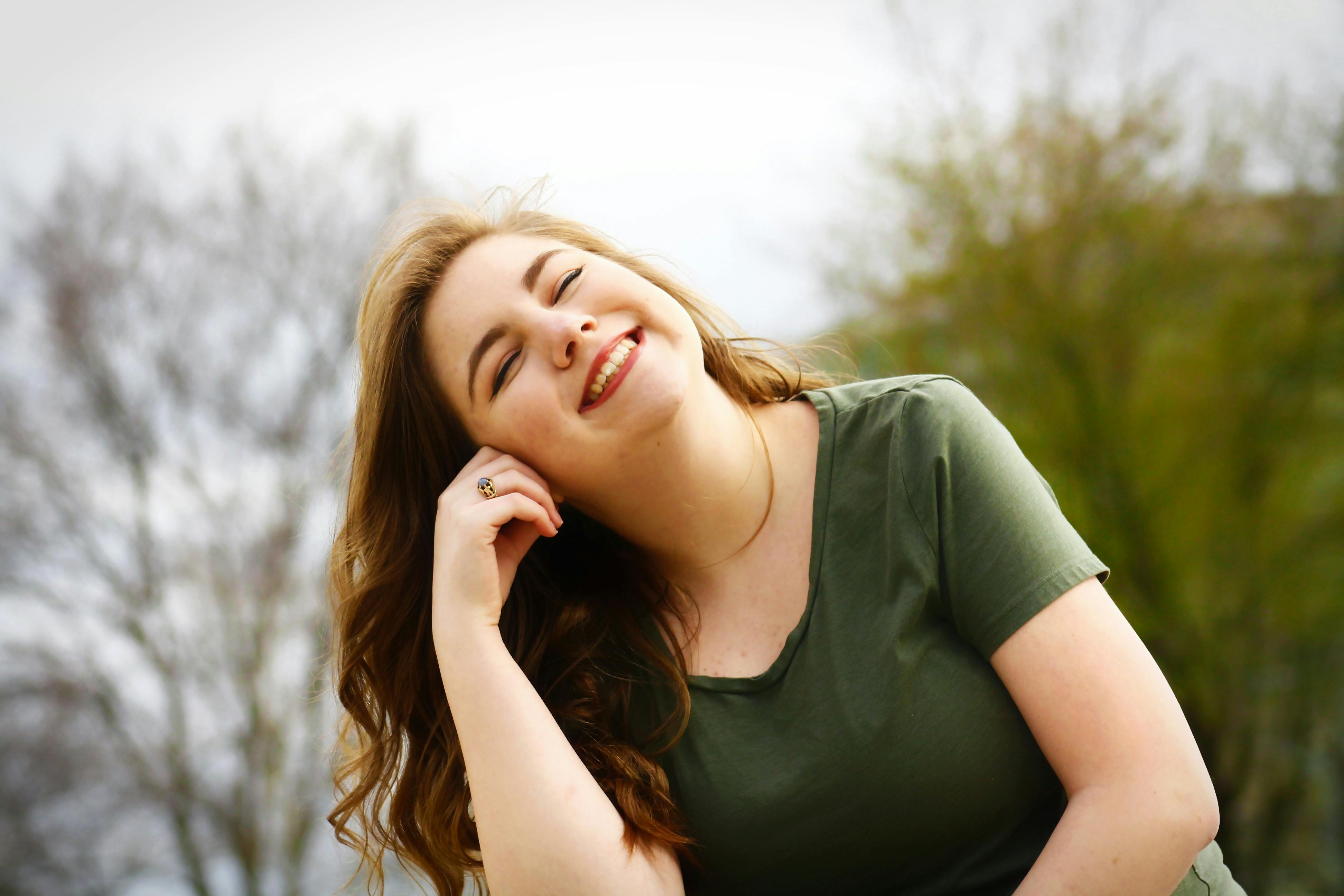A woman looking happy with her eyes closed while outside | Source: Pexels