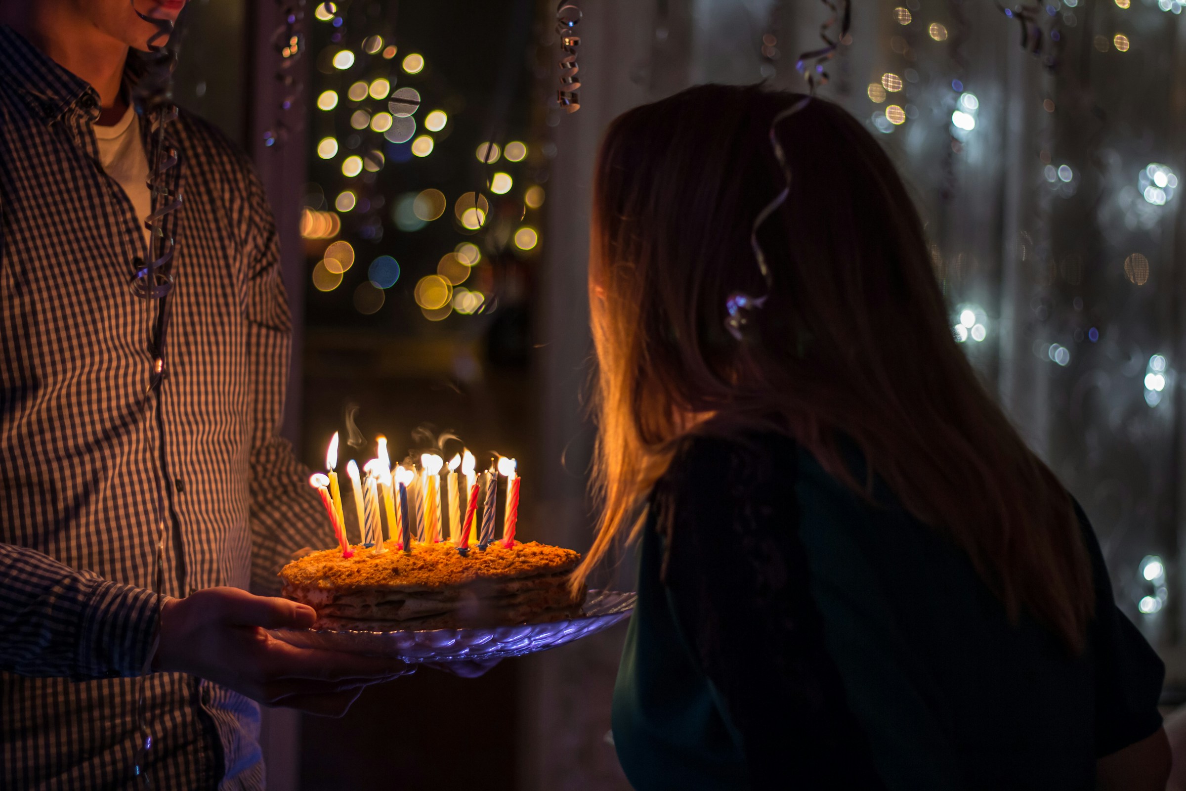 A young girl about to blow her birthday candles | Source: Unsplash