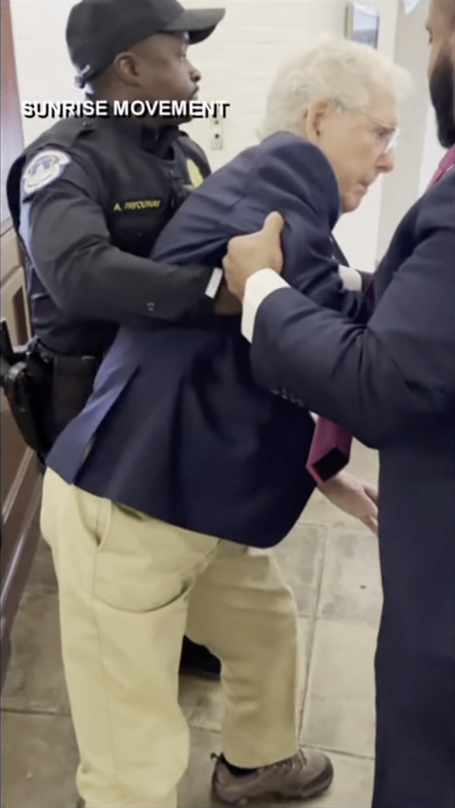 A Capitol Police officer and another aide lift Senator Mitch McConnell to his feet following the fall, as posted on October 16, 2025 | Source: YouTube/WHAS11News