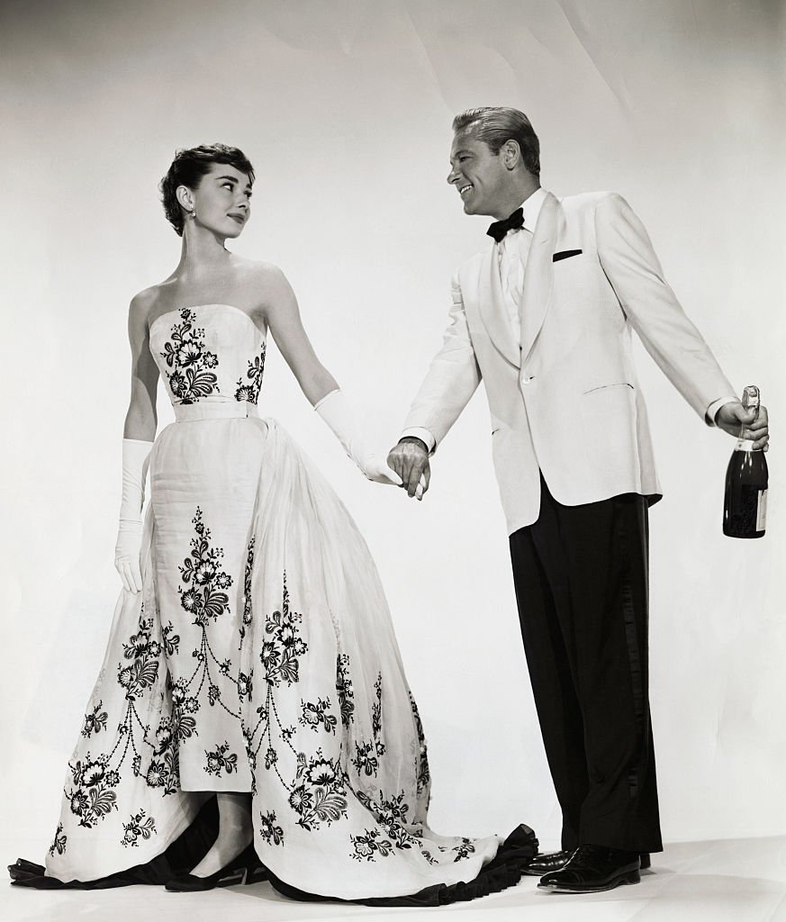 Audrey Hepburn and William Holden get into character as the ugly duckling-turned-beauty queen Sabrina Fairchild and charming millionaire playboy Linus Larrabee, respectively in "Sabrina" circa 1954. | Photo: Getty Images