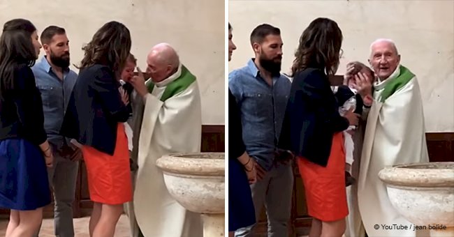 Priest slaps crying baby during baptism when he won't calm down (video)