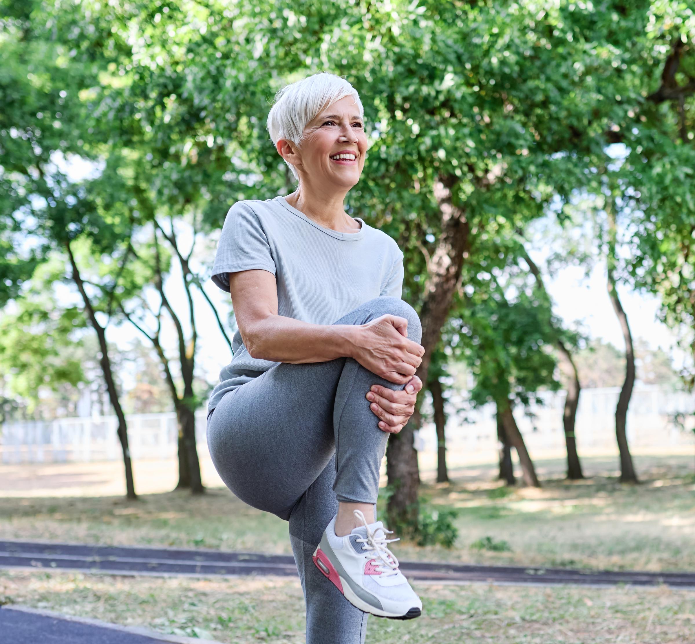 Woman doing light stretching outdoors | Source: Shutterstock