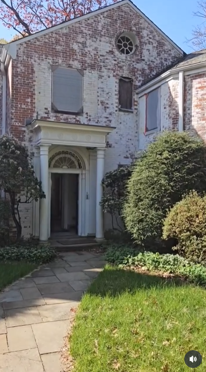 The rear of the home features arched lower-level openings and large windows offering views of the surrounding grounds | Source: Instagram/hudsonvalleyhouseparts
