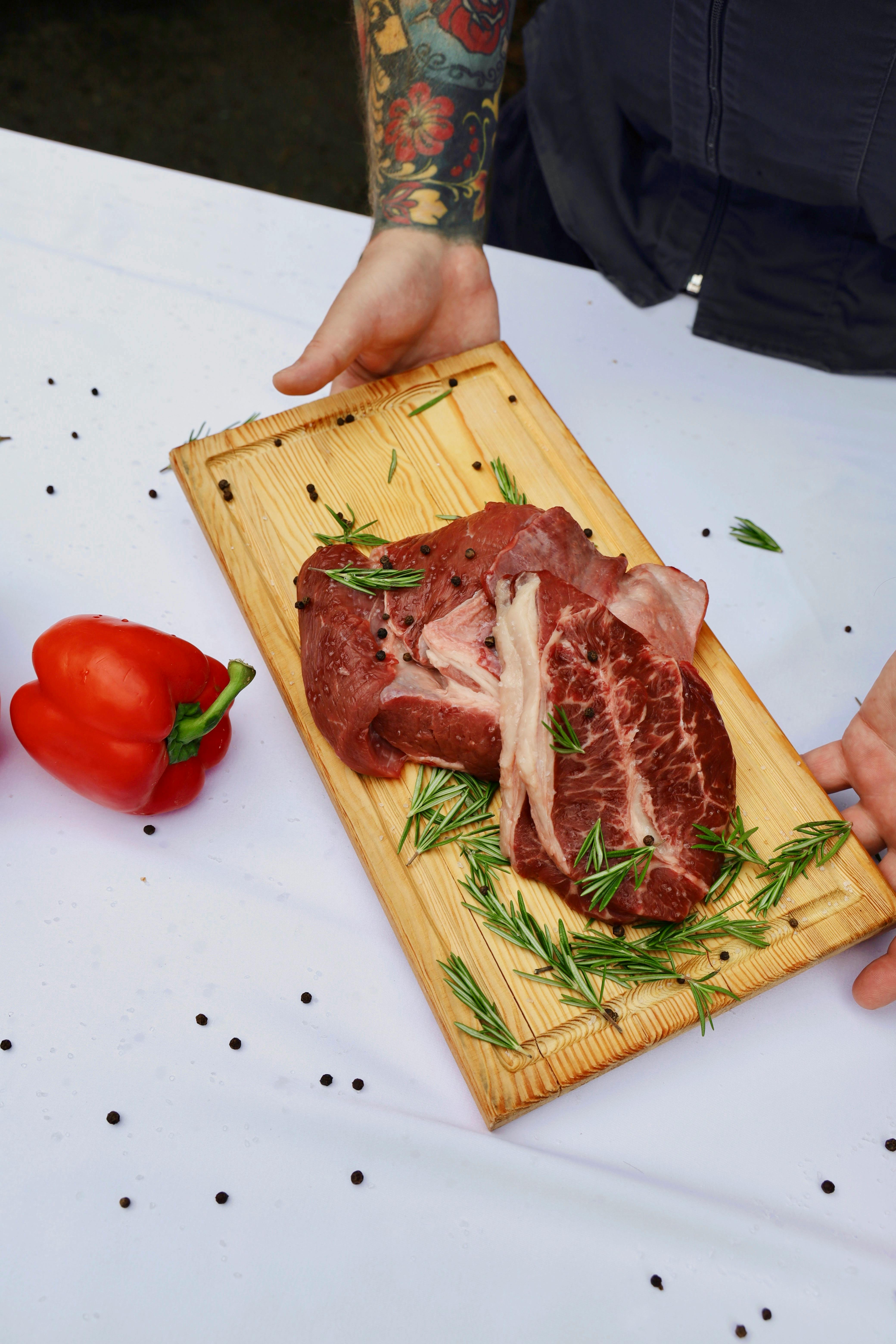 A beef steak on a wooden board. | Source: Pexels
