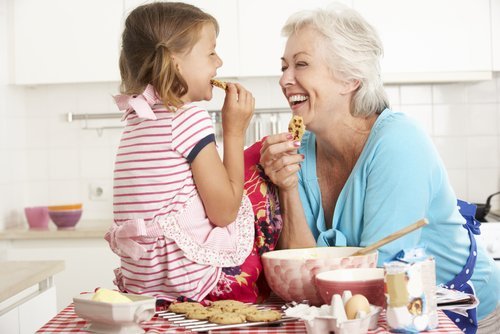 A grandmother and her granddaughter baking in the kitchen. | Source: Shutterstock. A grandmother and her granddaughter baking in the kitchen. | Source: Shutterstock.