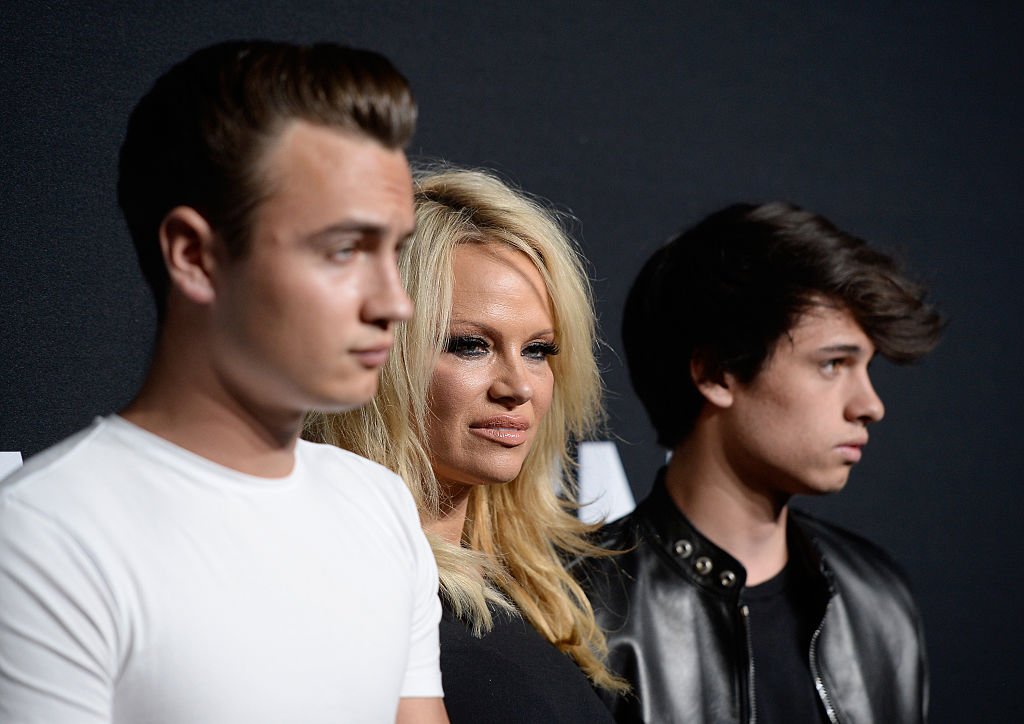 Pamela Anderson and her sons Brandon Lee (L) and Dylan Lee attend the Saint Laurent show at The Hollywood Palladium on February 10, 2016 in Los Angeles, California.  | Photo: GettyImages