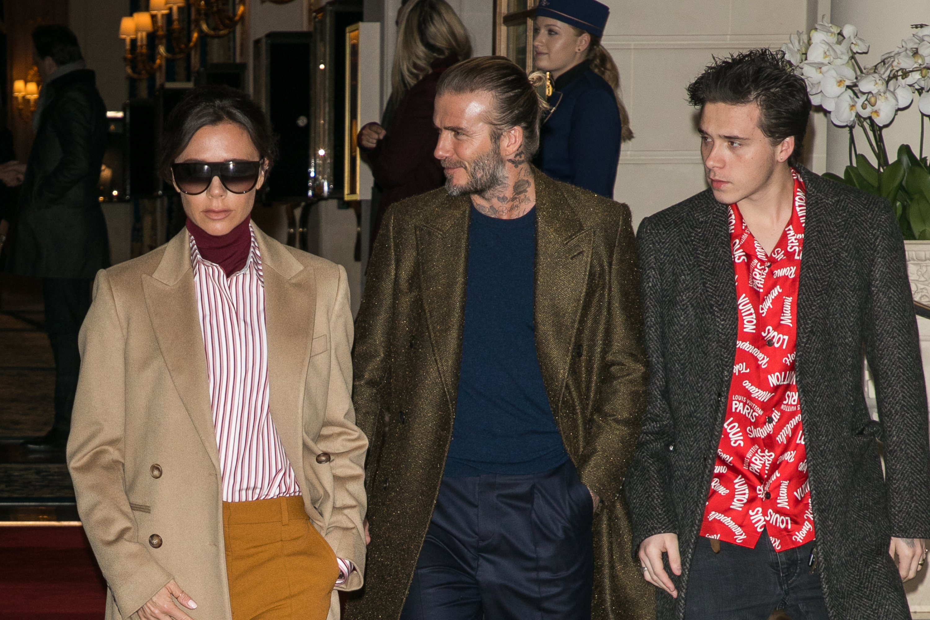 Victoria, David, and Brooklyn Beckham leave the Ritz Hotel in Paris, on January 18, 2018 | Source: Getty Images