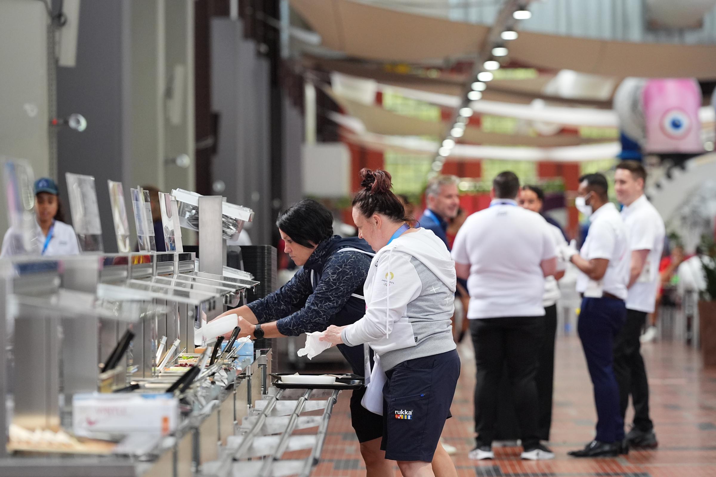 People enjoying food at a restaurant in the Olympic Village during the media open day on July 23, 2024, in Paris, France. | Source: Getty Images